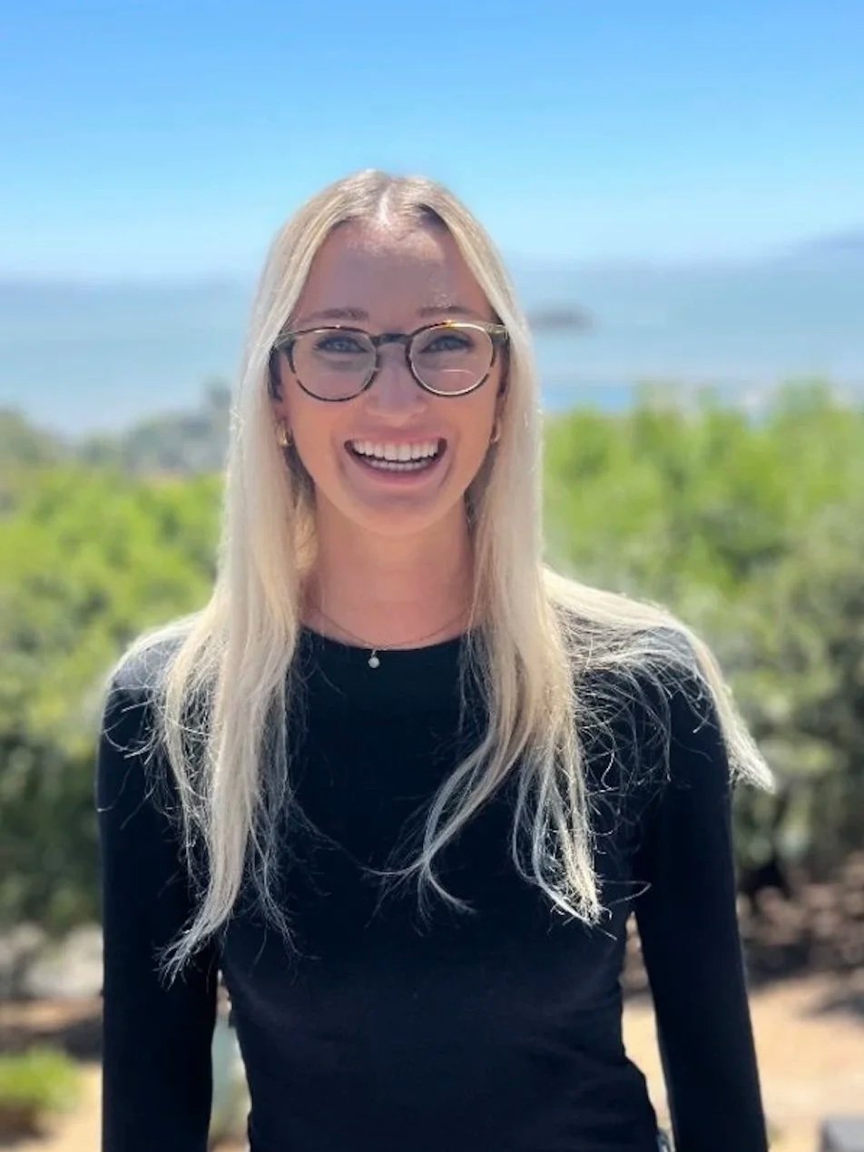 A warm female therapist standing outside in nature