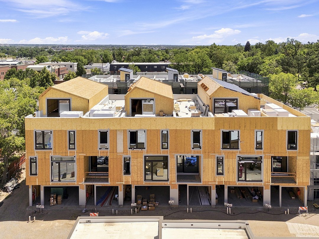 The distinctive La Vie Lumière roofline taking shape, showing the rooftop patios and extended living spaces that define the architecture