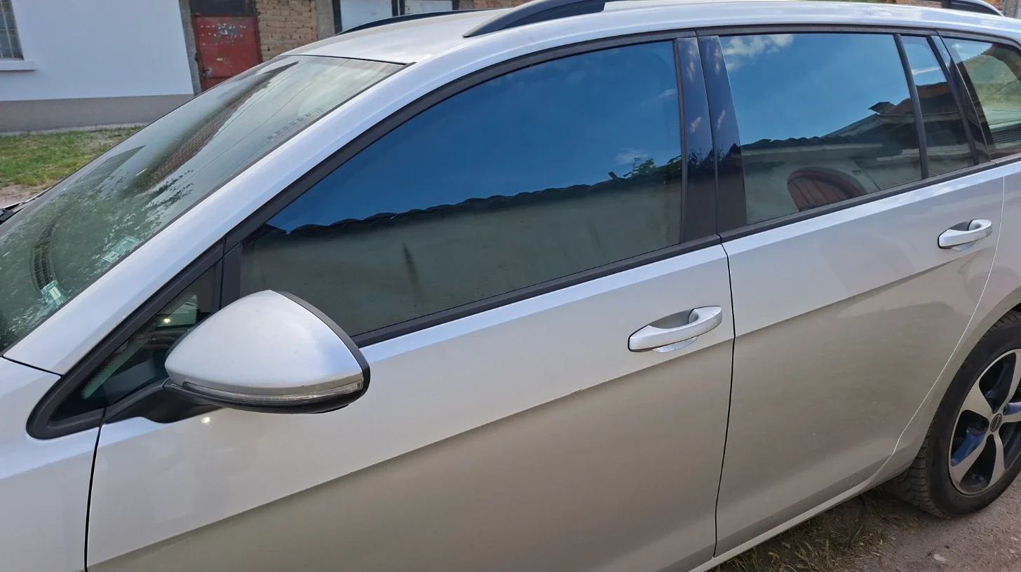 Black privacy window covers installed on the driver's side windows of a VW Golf Estate.
