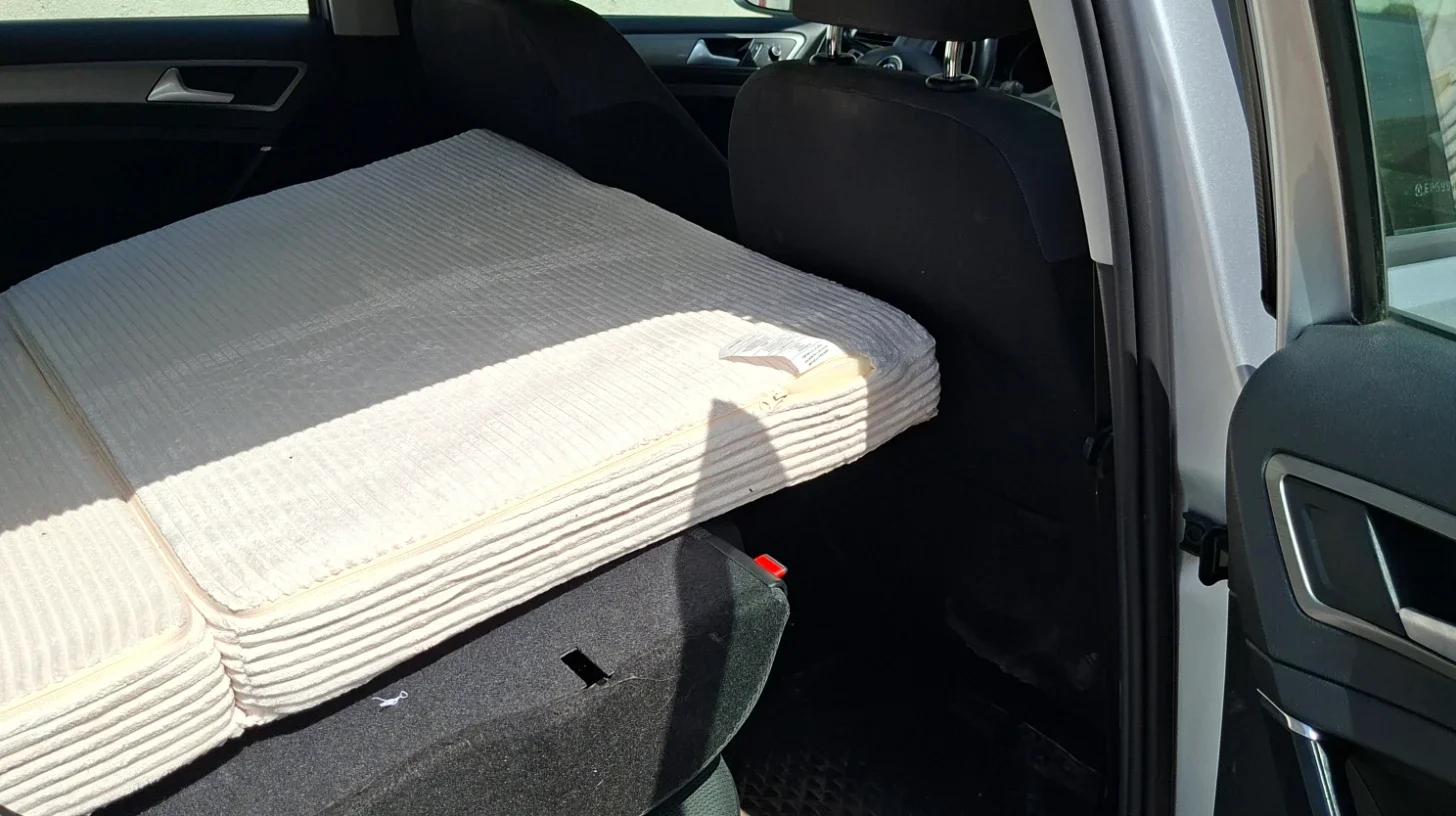 Foldable memory foam mattress deployed in a VW Golf Estate with the rear seats folded flat.