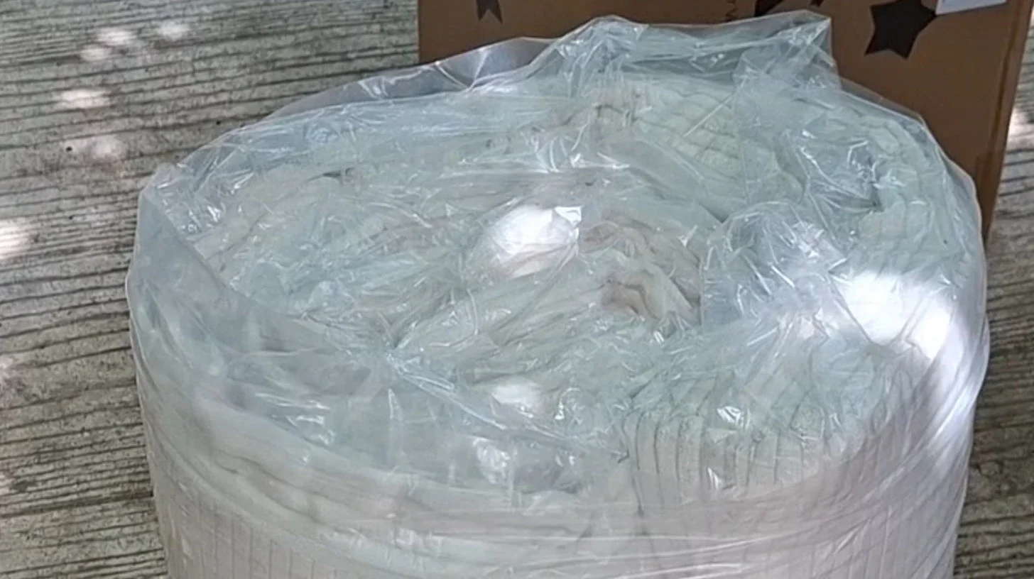 Memory foam mattress arriving vacuum packed before being fitted into a VW Golf Estate sleeping setup.