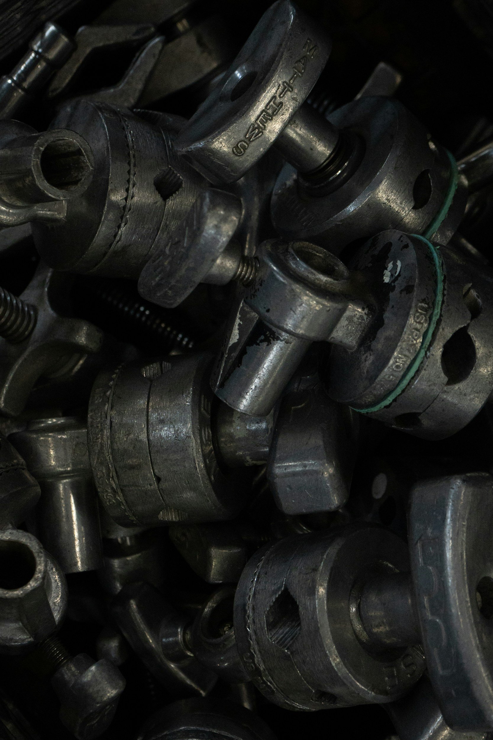 Close-up of metallic engine parts with various bolts, fittings, and components, showing mechanical details.