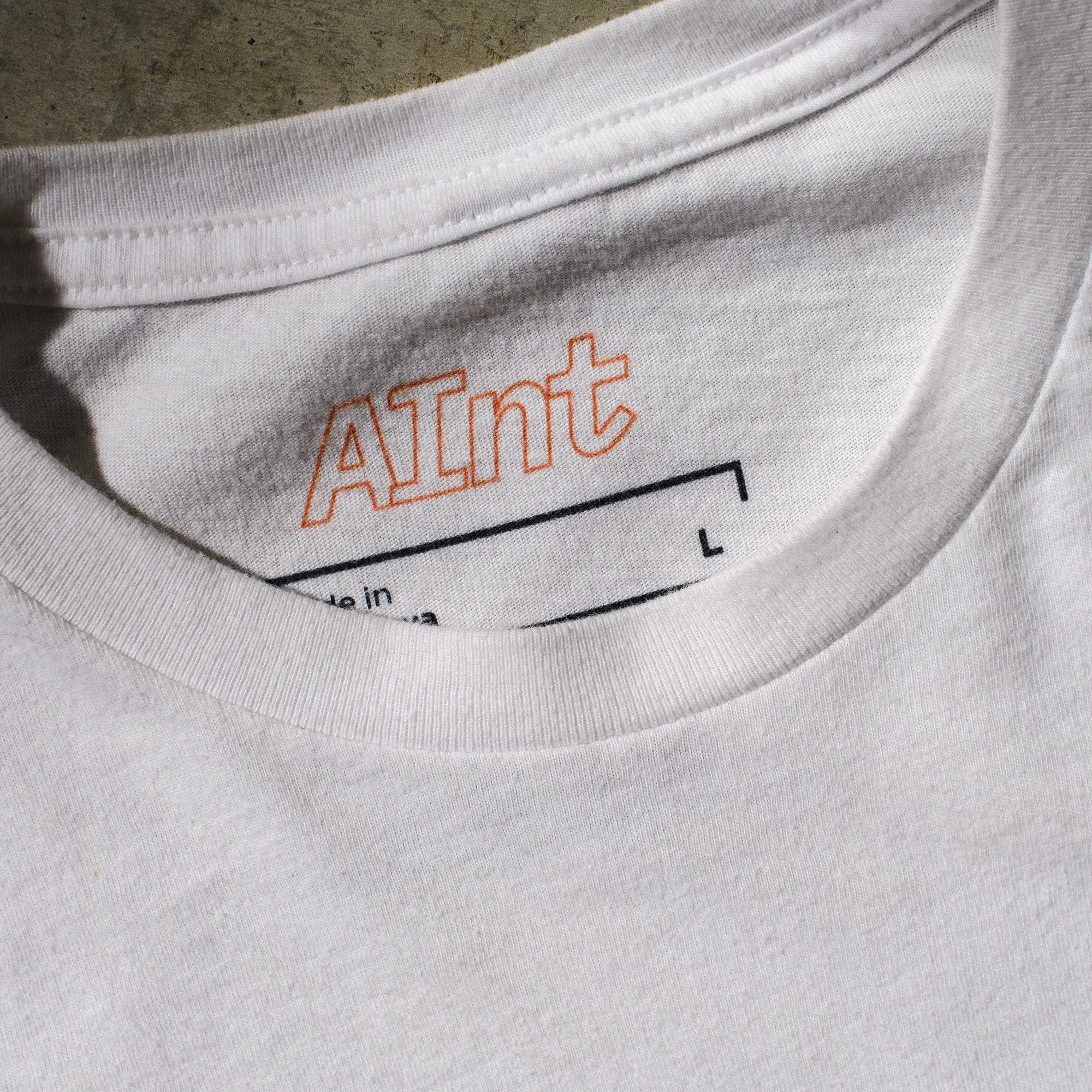 AInt-grenade-t-shirt-white-with-red-blue-black-halftone-grenade-collar-branding.jpg