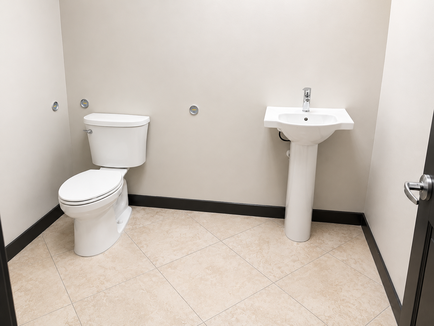 Professional commercial restroom installation featuring a water closet and pedestal sink completed with precision, quality, and code and compliant workmanship.