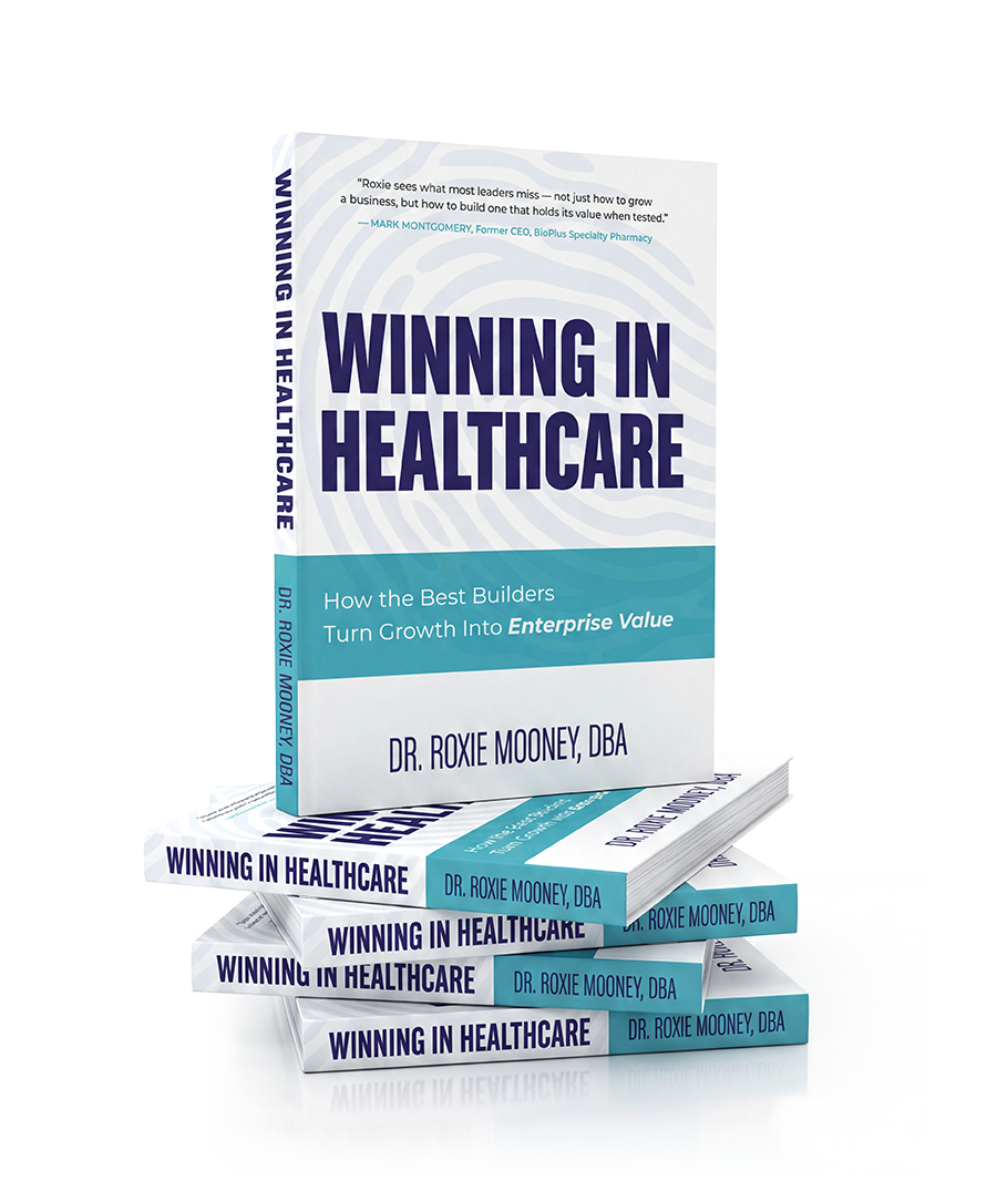 A stack of books titled 'Winning in Healthcare' by Dr. Roxie Mooney, DBA, with a cover showing a blue and white design and a quote at the top.