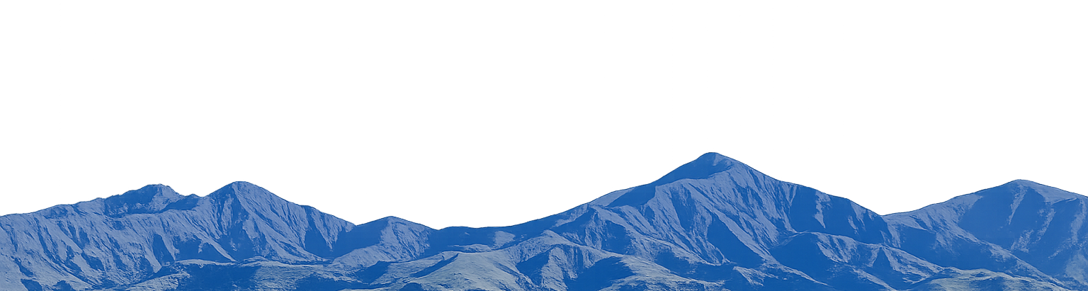 Snow-covered mountain range with multiple peaks under a clear sky.