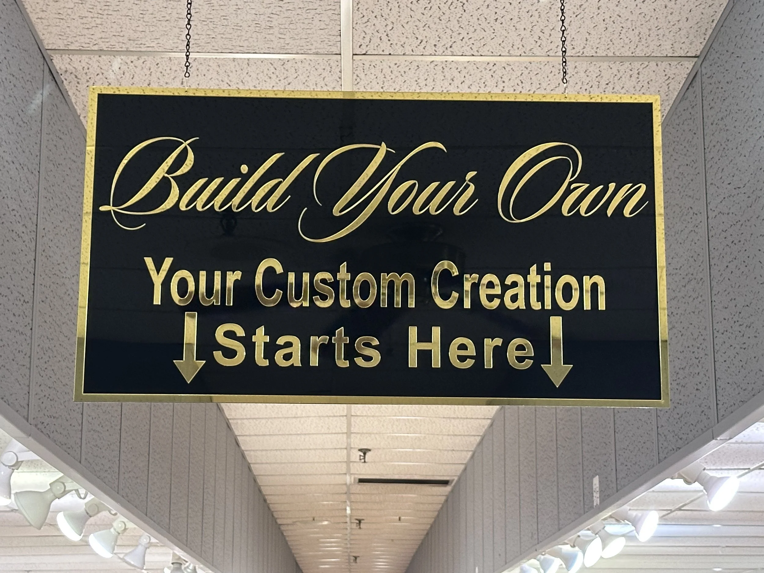 custom business sign. black and gold mirrored acrylic sign