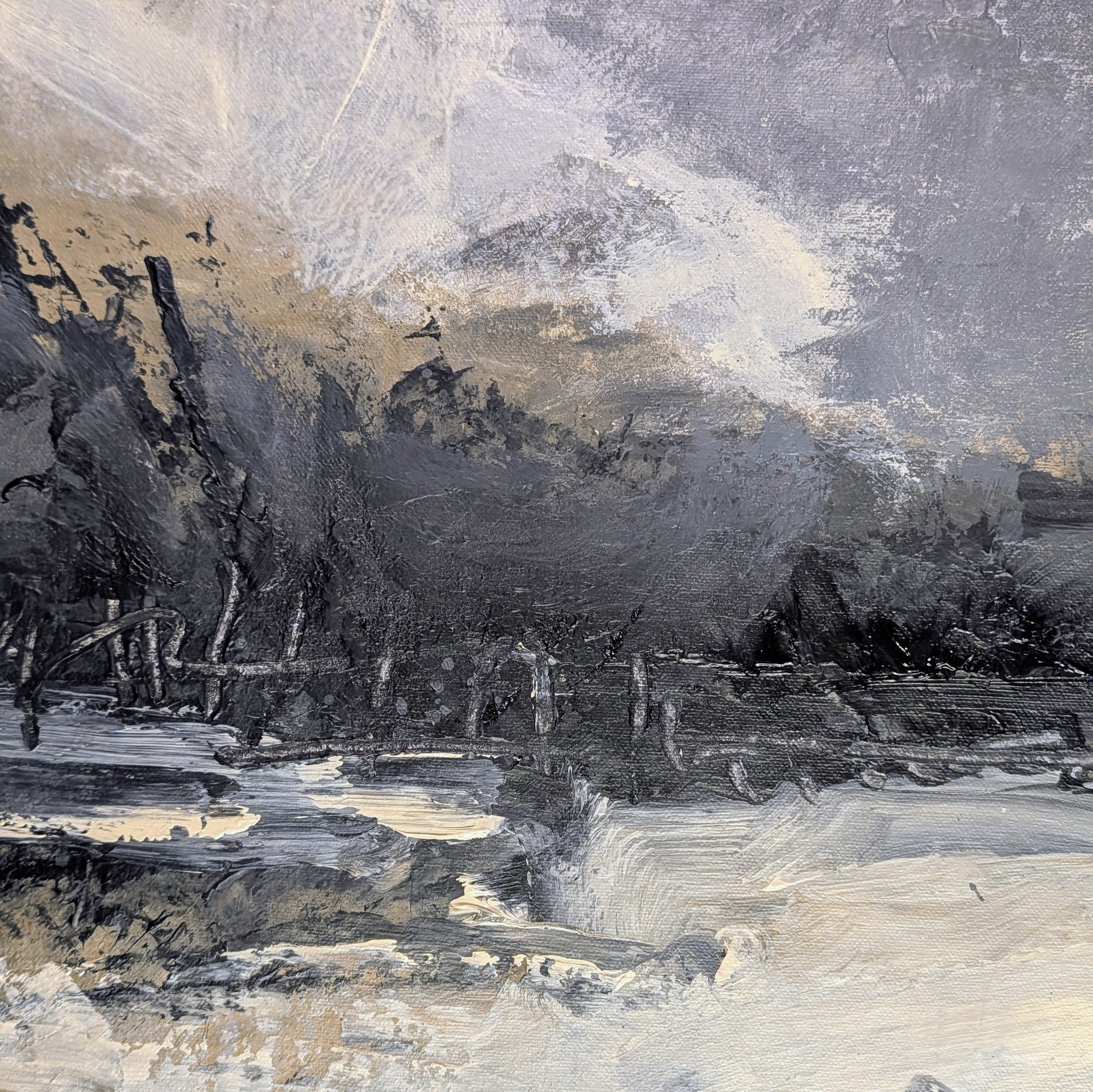 Close-up of textured acrylic paint with layered charcoal, gray, sand, and warm white marks across a weathered abstract surface.