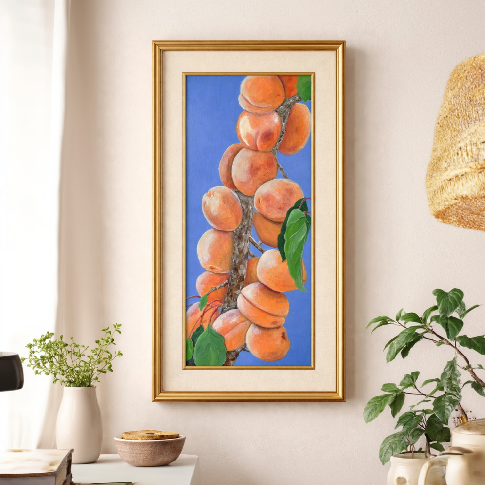 Peach Branch Still Life Painting by Tricia Sauls shown framed in a room mockup for scale and styling reference