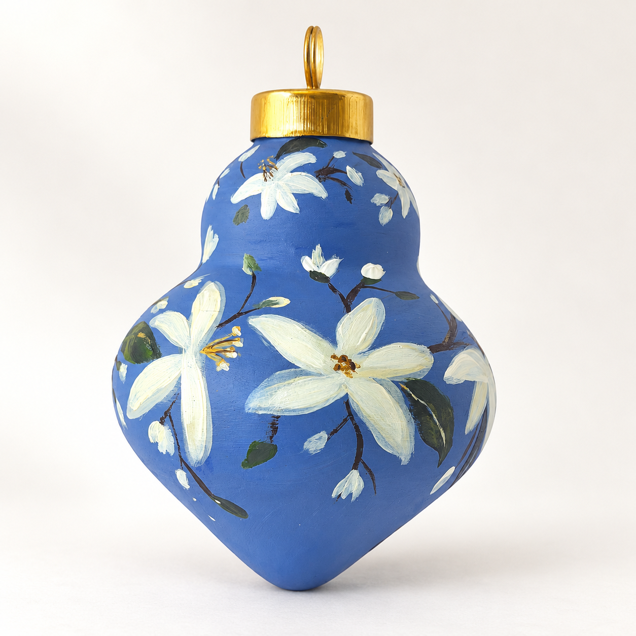 Blue floral ornament on warm ivory.png