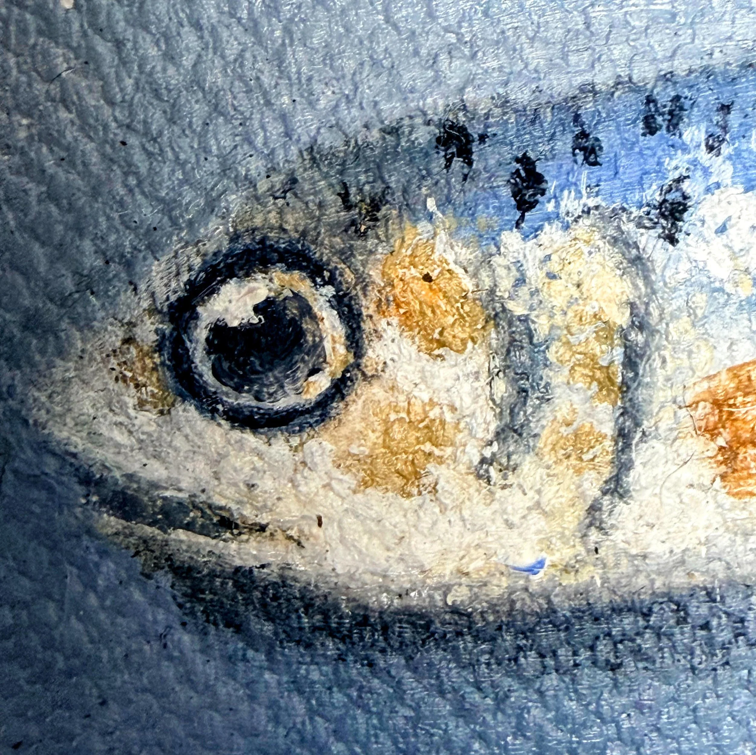 Close-up of a miniature sardine painted in oil with reflective blue-silver highlights, a dark eye, small markings, and visible canvas texture.