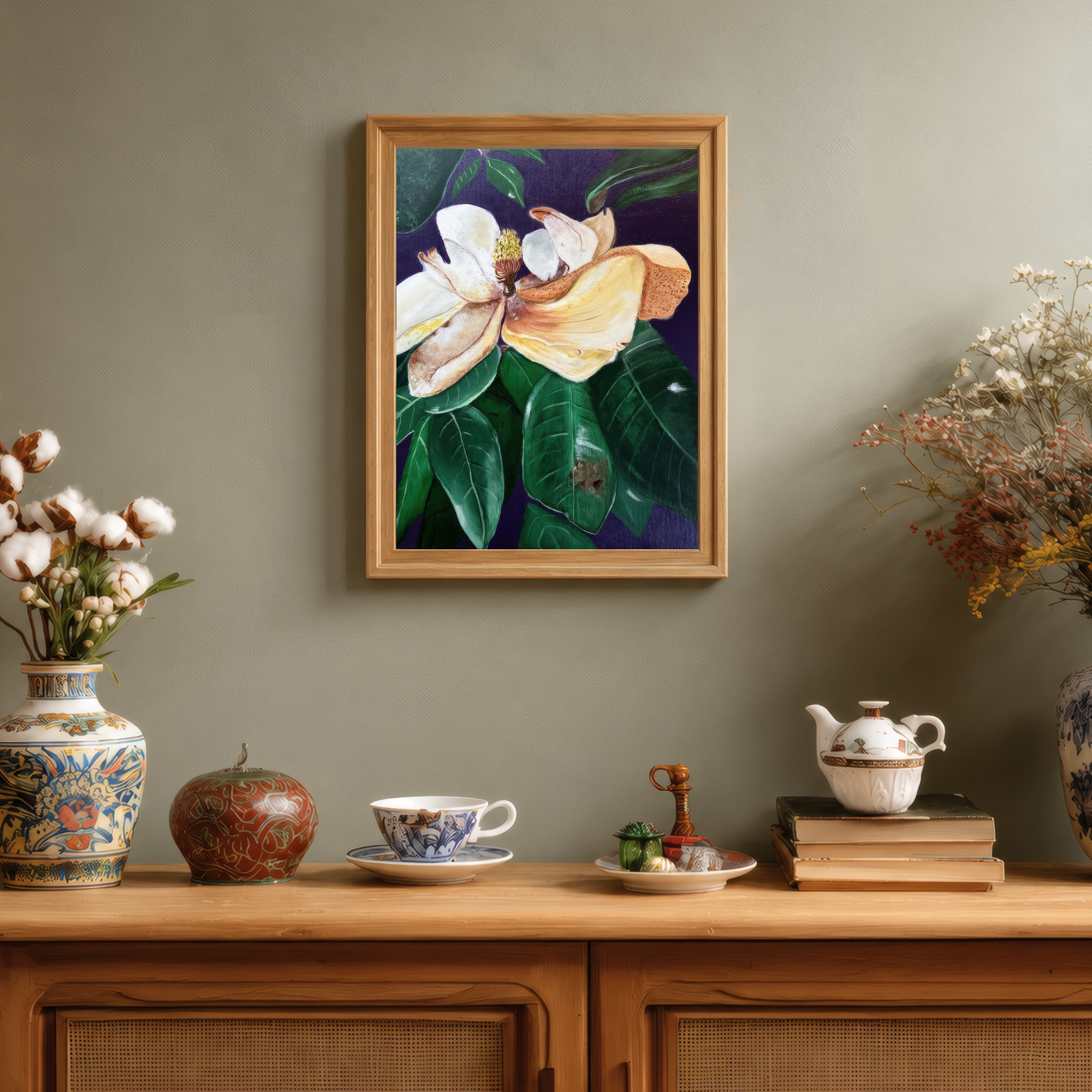 Magnolia Flower Wilting by Tricia Sauls shown framed in a room mockup for scale and styling reference