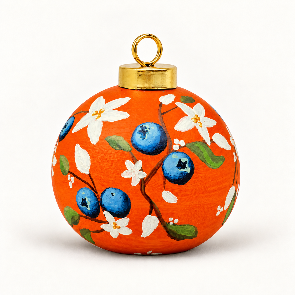 Orange ceramic ornament with blue berries.png