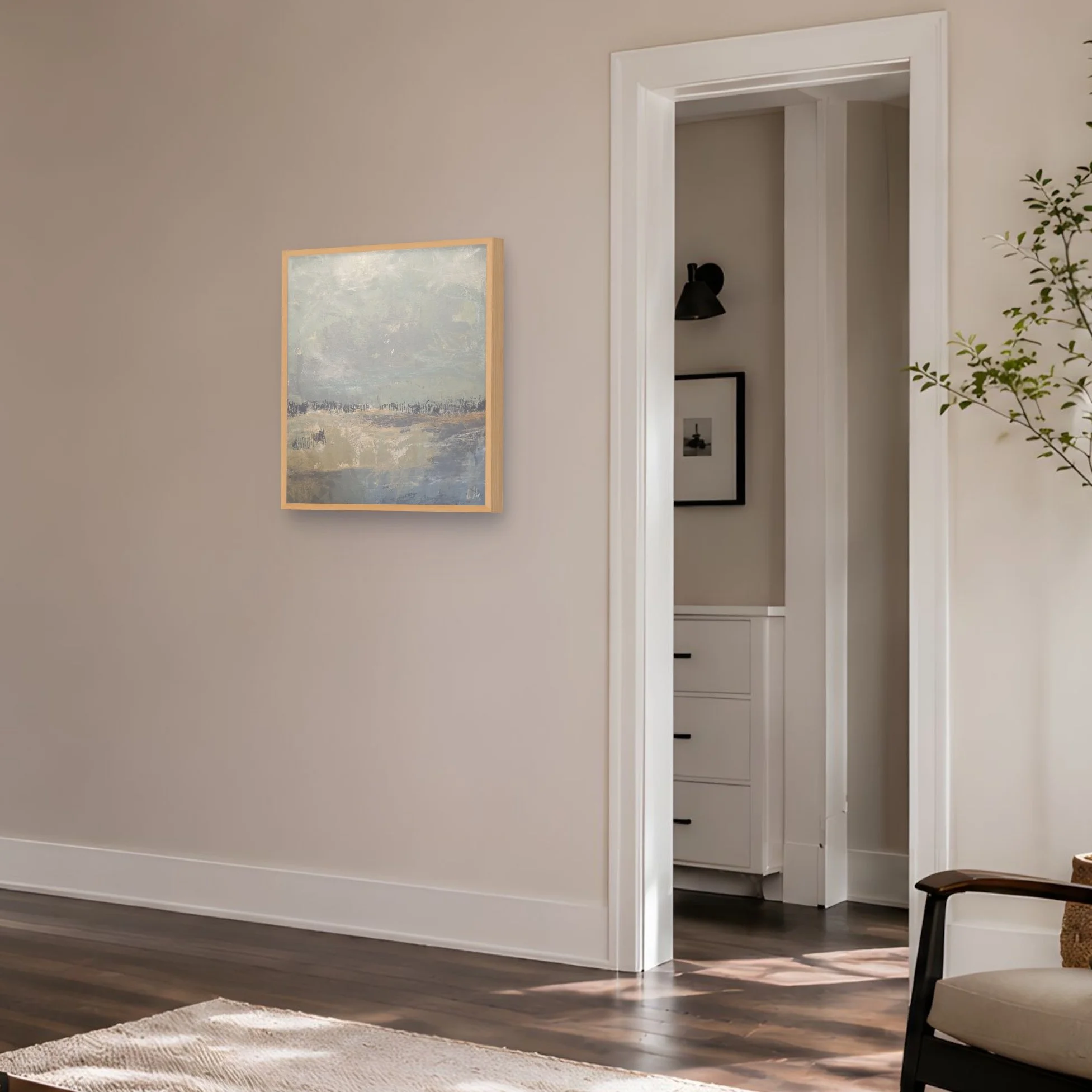 Square abstract landscape painting displayed in a calm modern interior with muted coastal tones, pale neutrals, and layered surface texture.