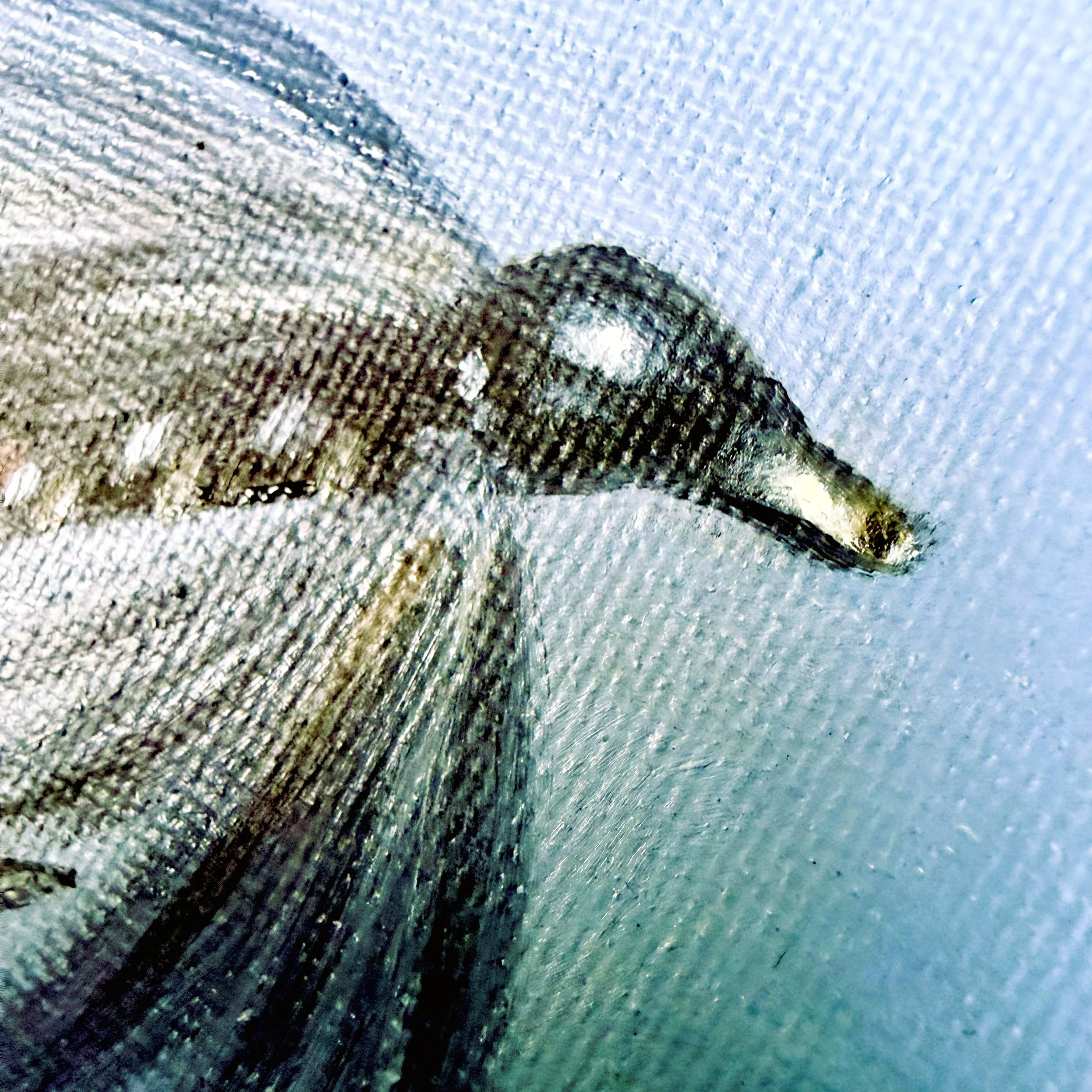 Close-up of a miniature fishing fly painted in oil with dark feather-like brushwork, translucent gray wing detail, vivid red tail fibers, hook detail, and visible canvas texture.