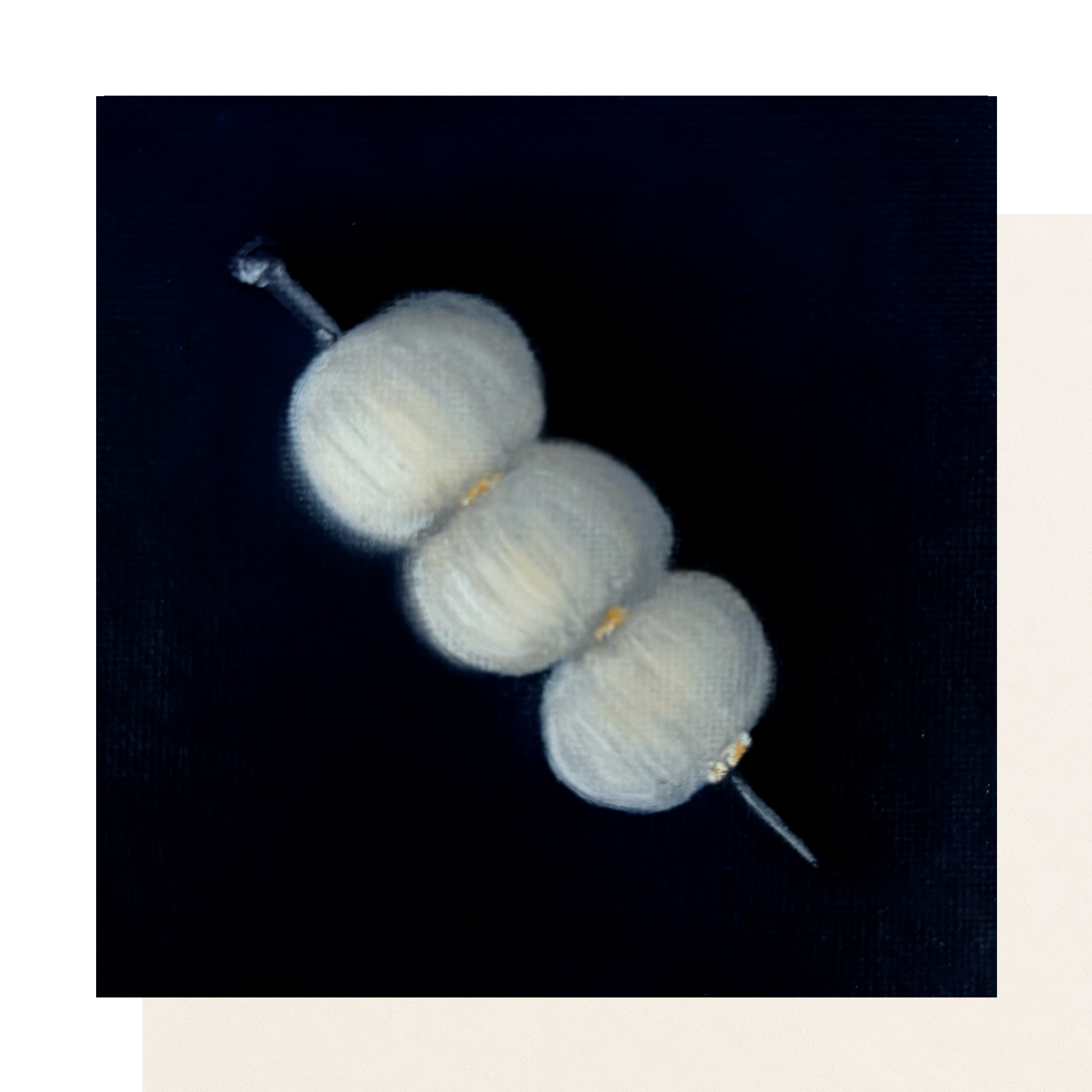 Original 4 x 4 inch oil painting of three pale cocktail onions or white olives arranged on a pick against a deep navy textured background on canvas board.