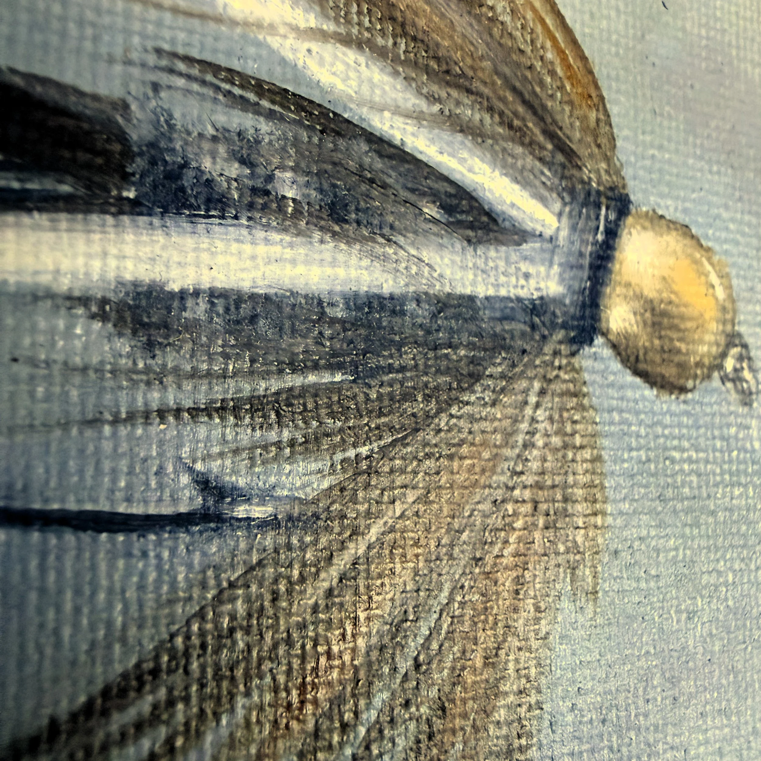 Close-up of a miniature fishing fly painted in oil with silvery white brushwork, olive-toned feather detail, subtle hook shape, and visible canvas texture.
