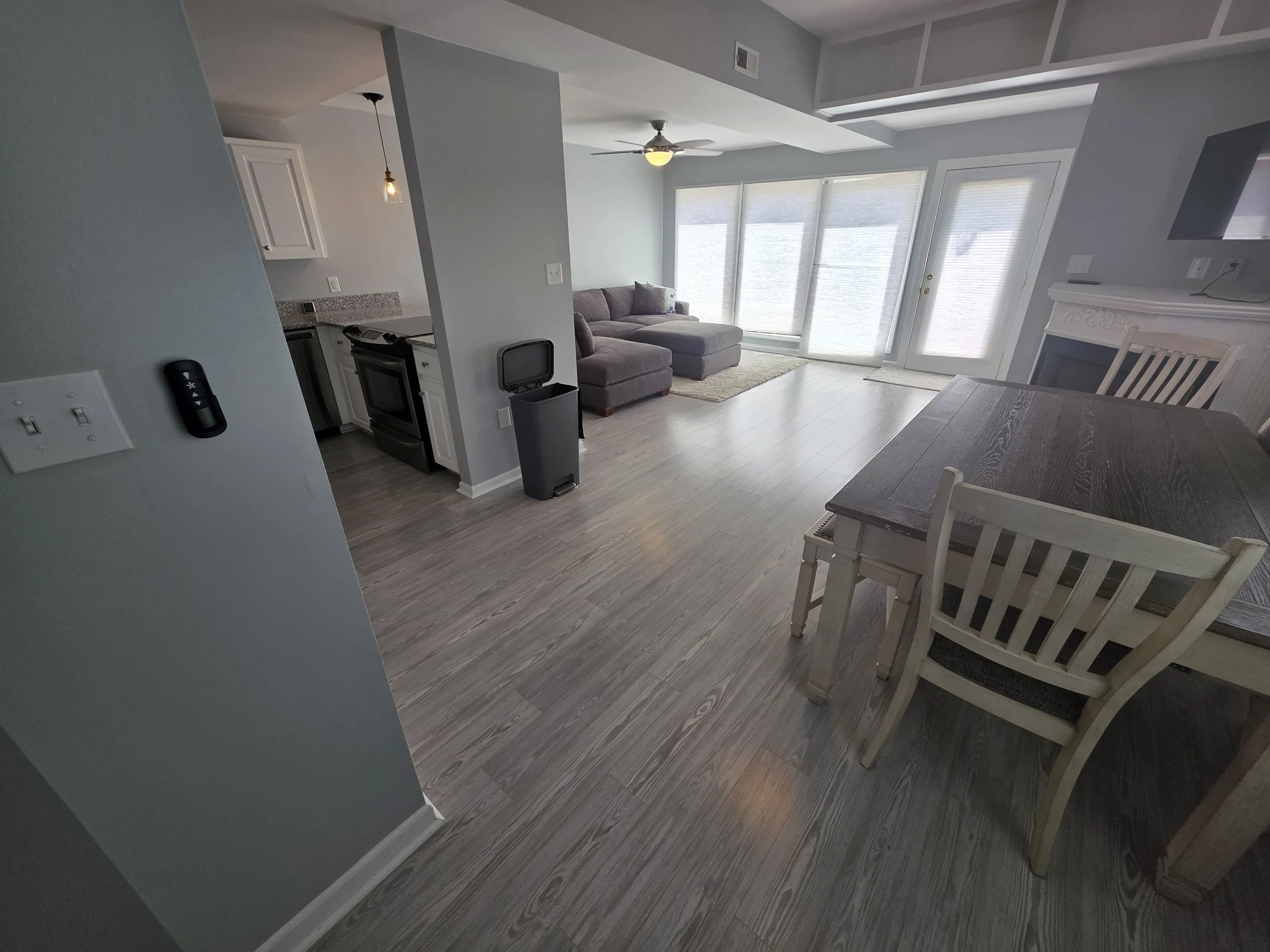 Open-concept living room in a Lake Greenwood waterfront townhouse with large windows and natural light.