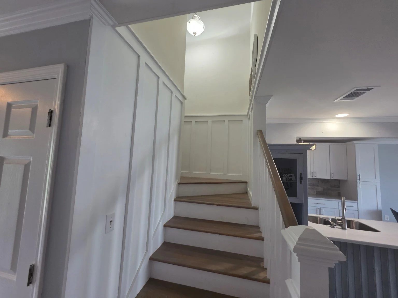 Updated staircase with board-and-batten detailing inside the Pier 96 townhome