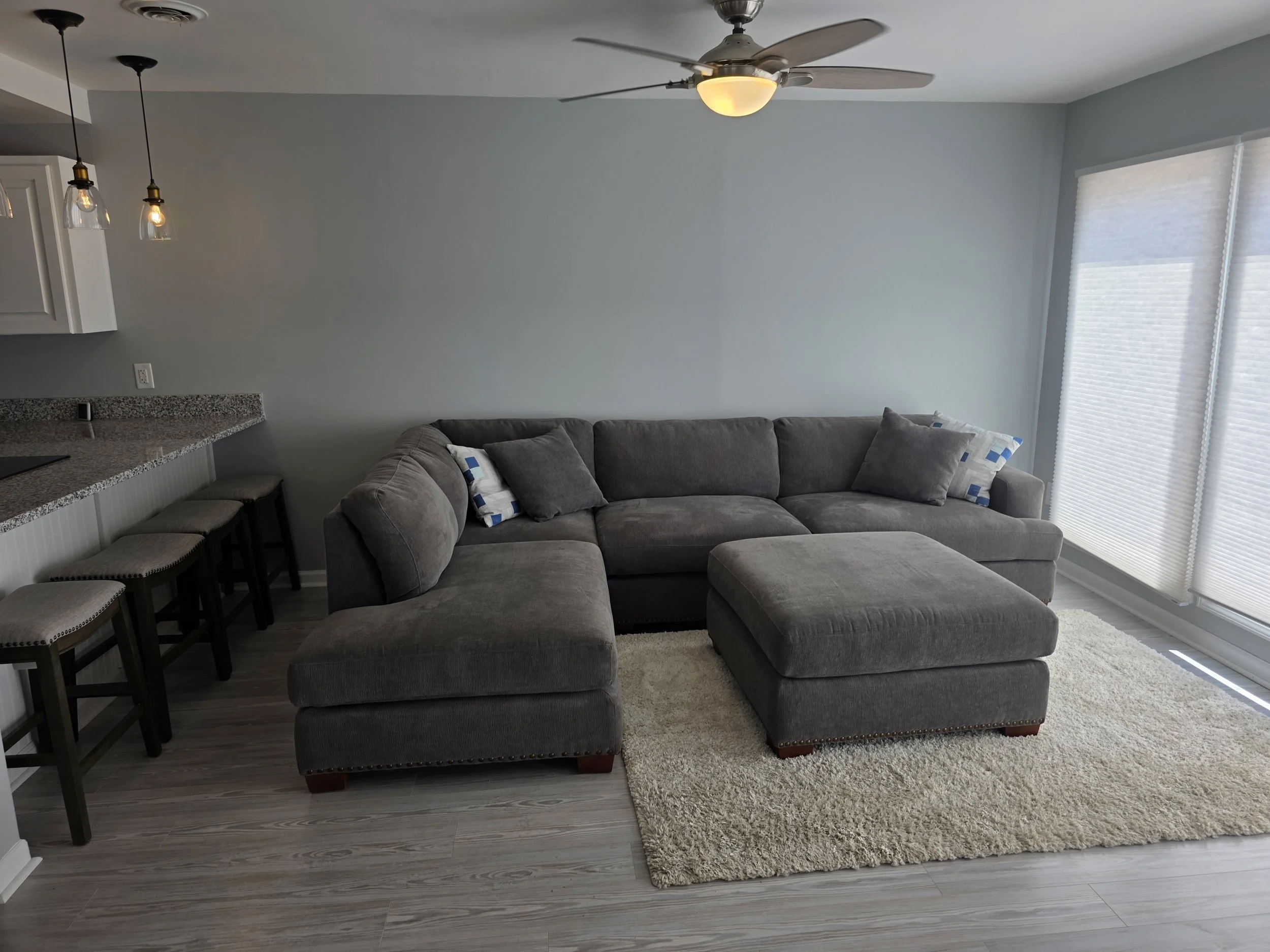 Living room with large windows, natural light, and views toward Lake Greenwood in a waterfront townhouse.