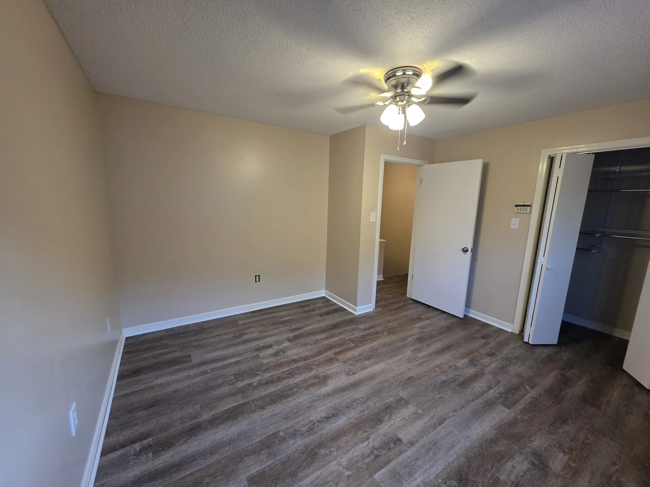 Upstairs bedroom with new LVP flooring and an open closet at 107 Country Village Ct in Greenwood