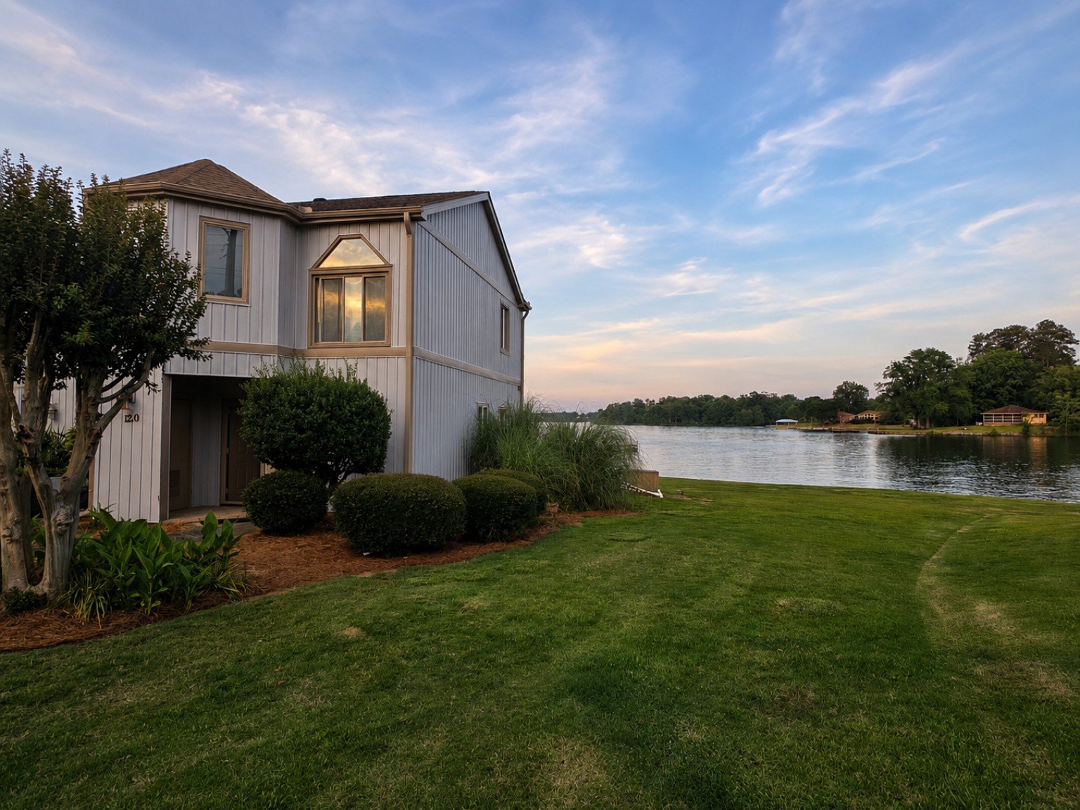Professional exterior listing photo of a clean lakefront rental home, demonstrating high-quality marketing photography that helps attract prospective tenants.