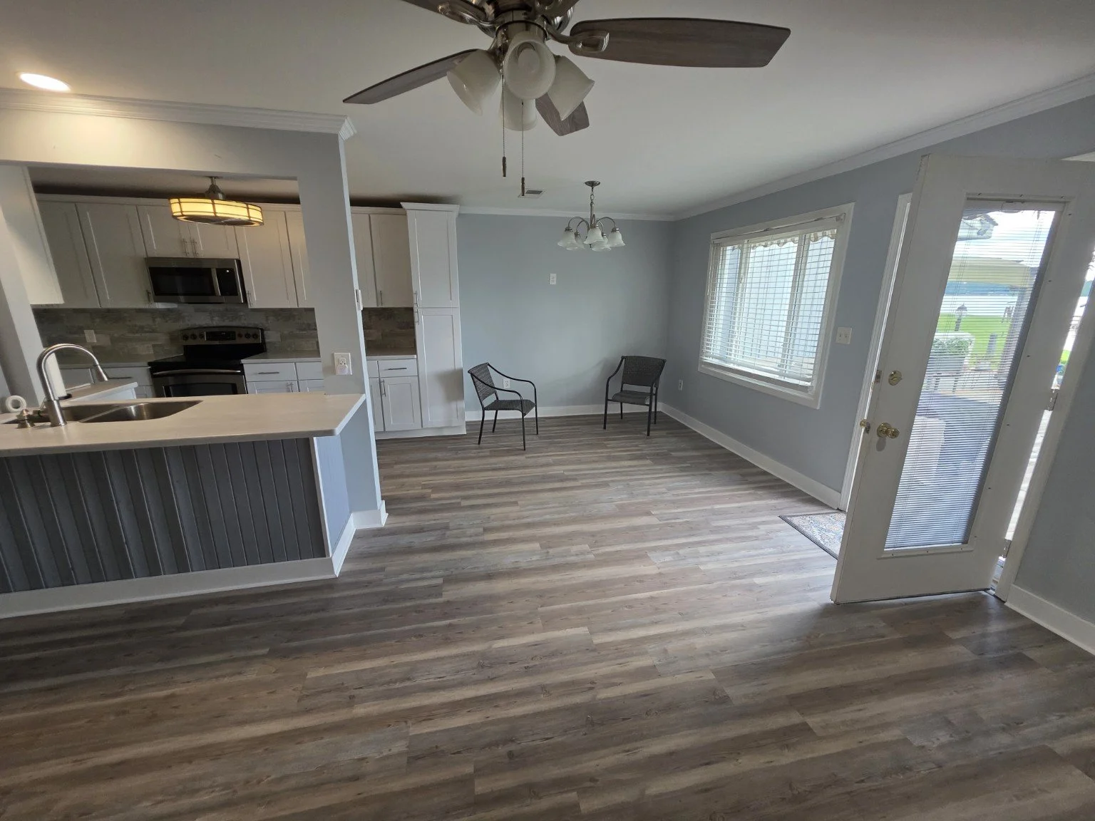 Open kitchen and living area with luxury flooring and natural light in the Lake Greenwood townhome