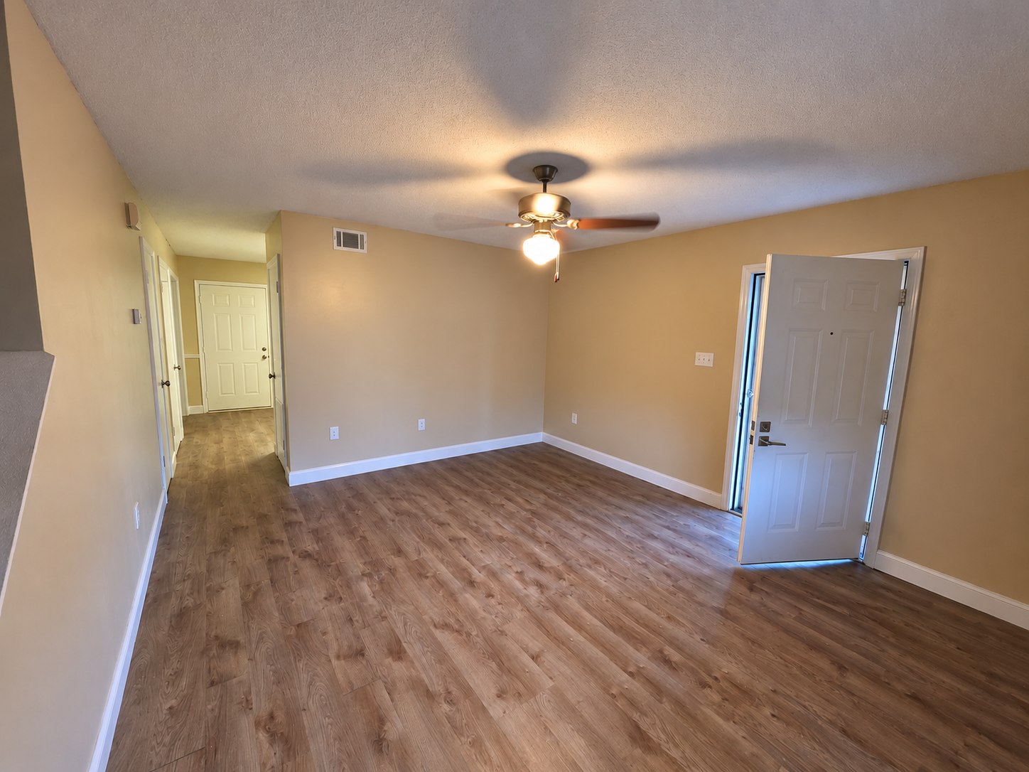 Spacious living room with LVP flooring and neutral walls in a Greenwood, SC townhouse for rent