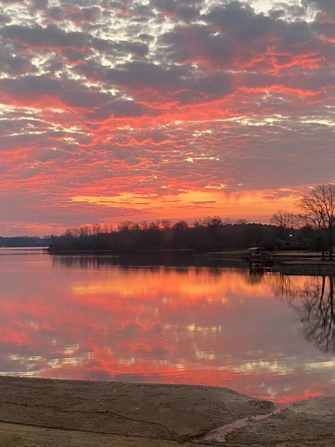 Colorful Lake Greenwood sunset reflecting across the water at Pier 96