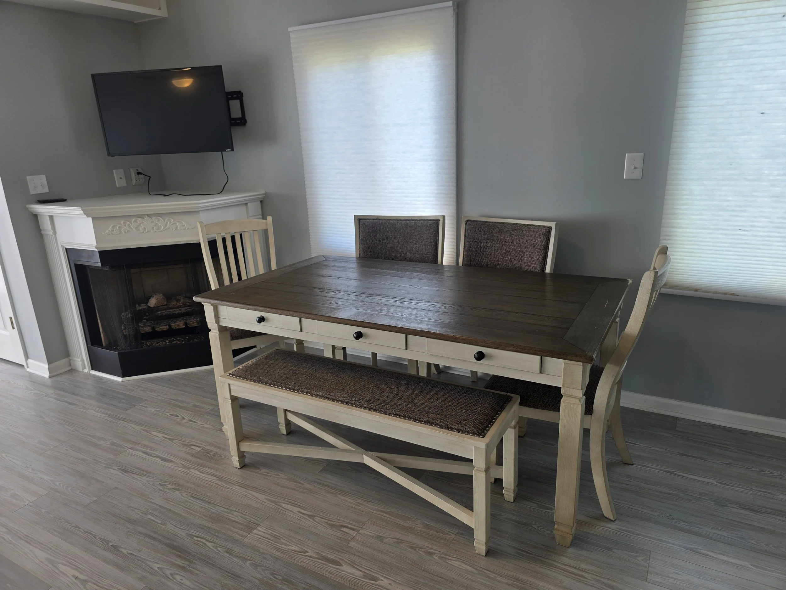Dining area with a cozy corner fireplace in a Lake Greenwood waterfront townhouse.