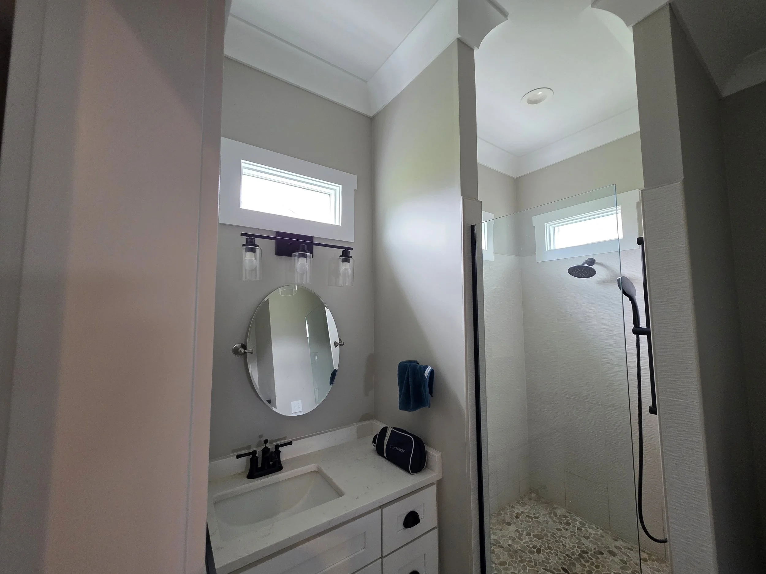 Primary bathroom with walk-in tile shower in Greenwood SC rental home.