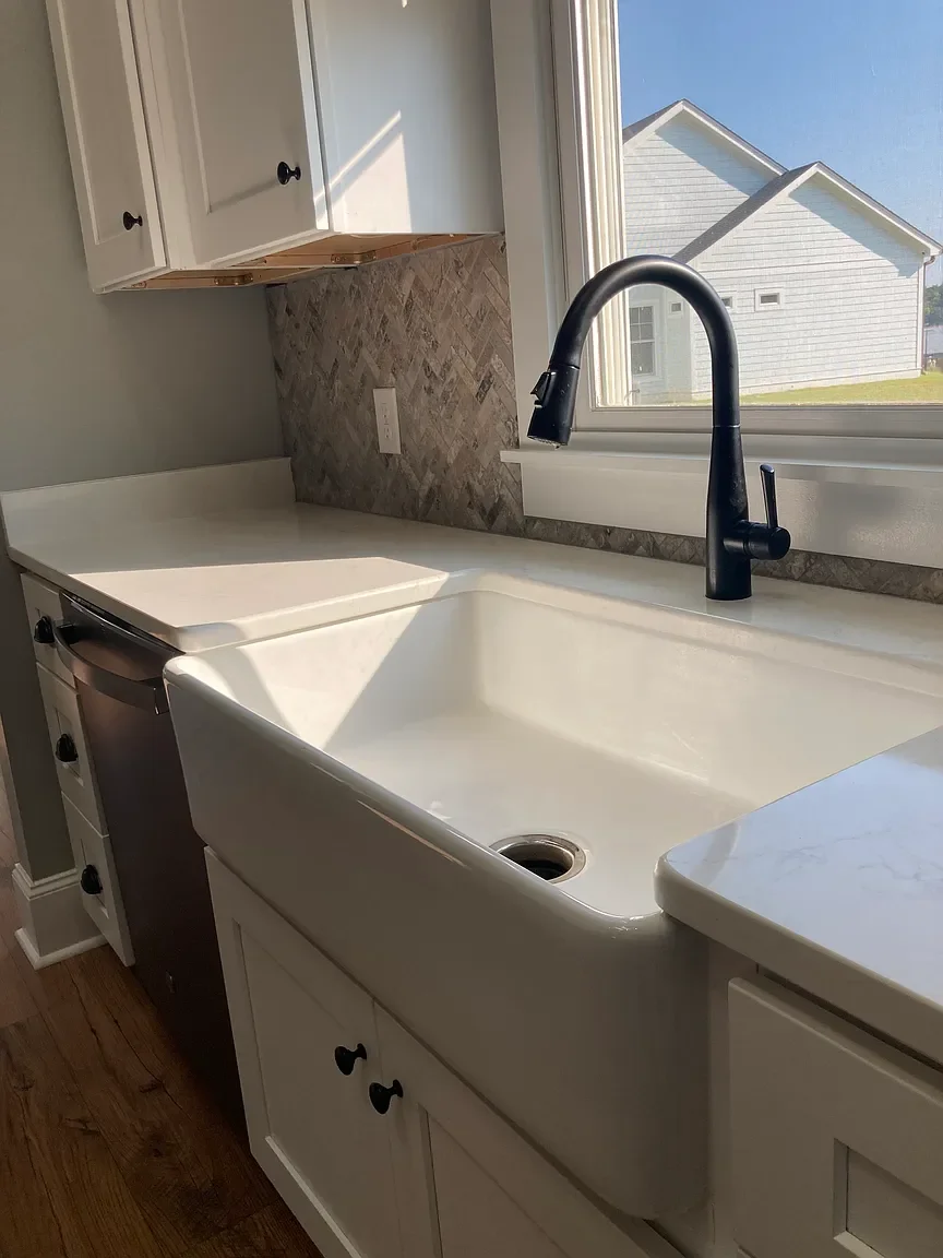 Farmhouse sink and custom kitchen finishes in Greenwood SC rental home.