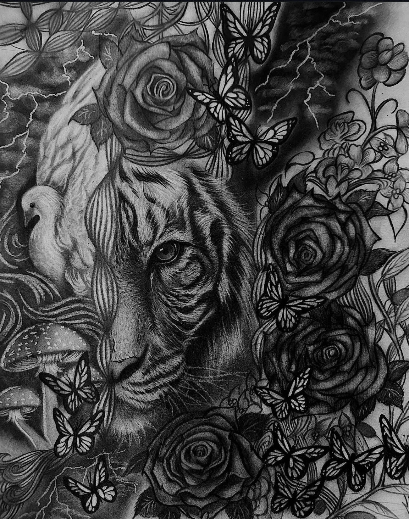 Black and white tattoo art featuring a tiger's face surrounded by roses, butterflies, a bird, mushrooms, and lightning.