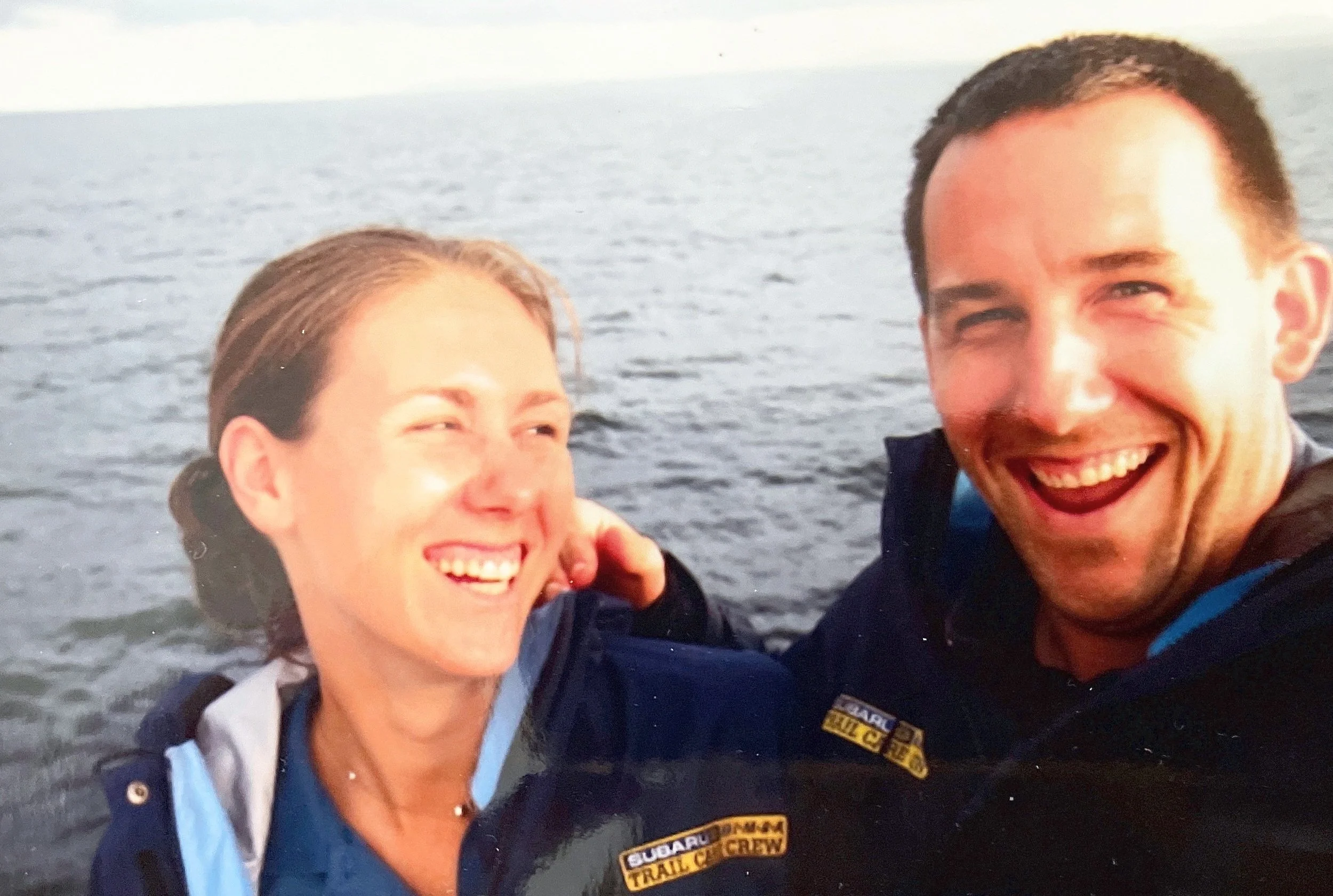 Aaryn Kay and Scott Linnenburger during their Subaru/IMBA Trail Care Crew days with a background of a body of water and sky.