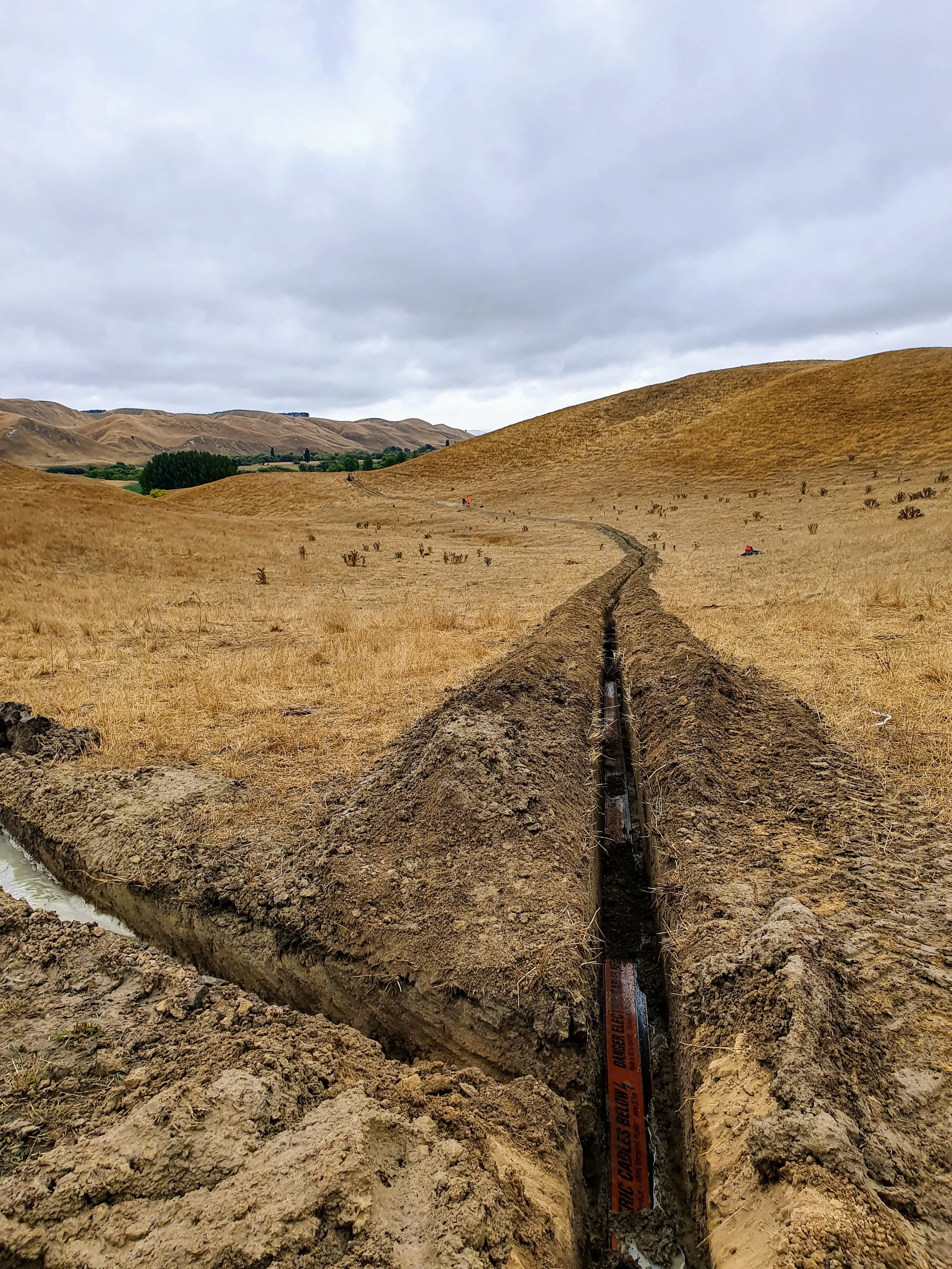 Underground power cable trenching across rural Hawke's Bay farmland by DB Electrical