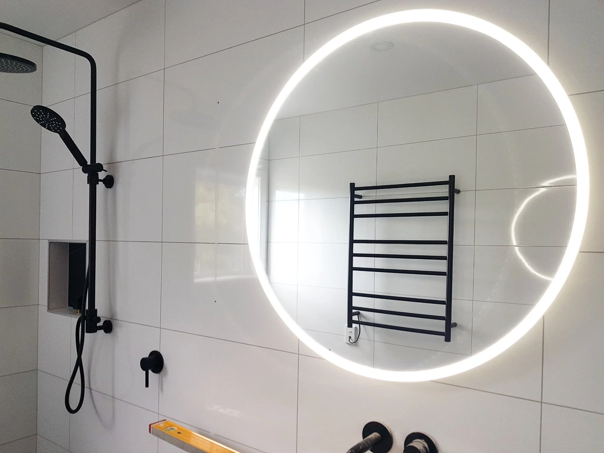 Round LED mirror and heated towel rail installed in bathroom by DB Electrical, Napier, Hastings, Havelock North, Hawke's Bay electricians
