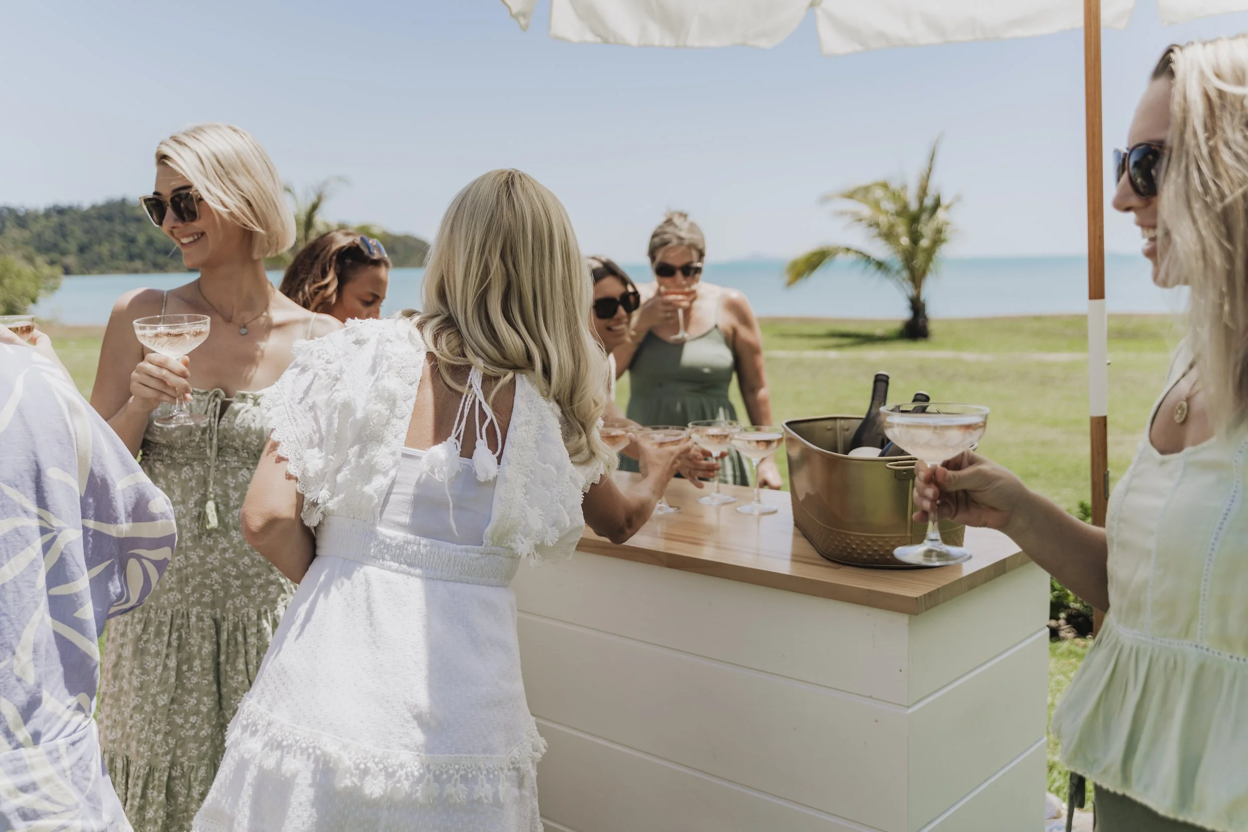 Luxury private celebration styled by Salt & Silk Collective in Airlie Beach, featuring guests enjoying a beautifully styled outdoor event in the Whitsundays.