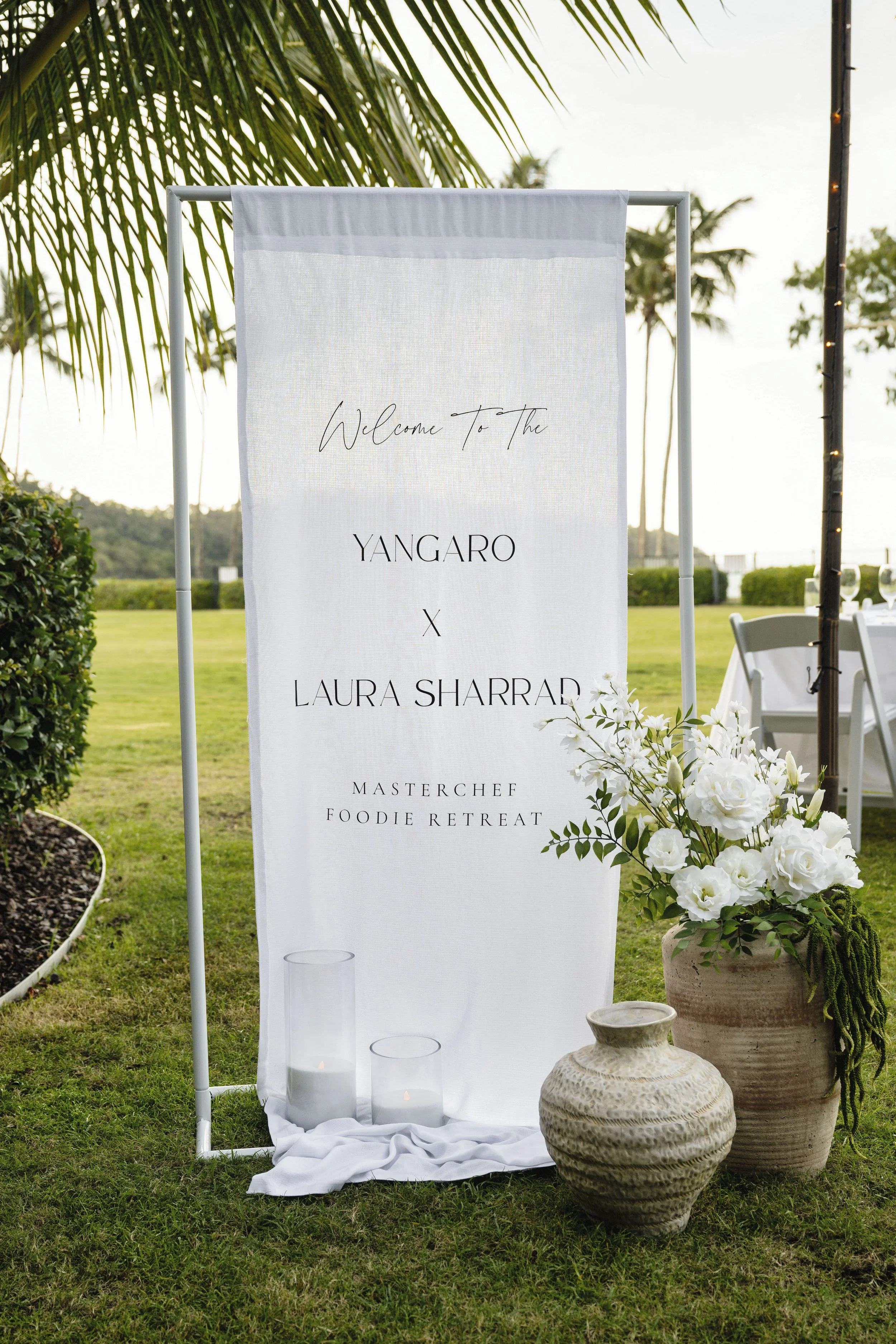Luxury wedding welcome sign with white floral styling by Salt & Silk Collective at Yangaro Resort in Airlie Beach, Whitsundays.