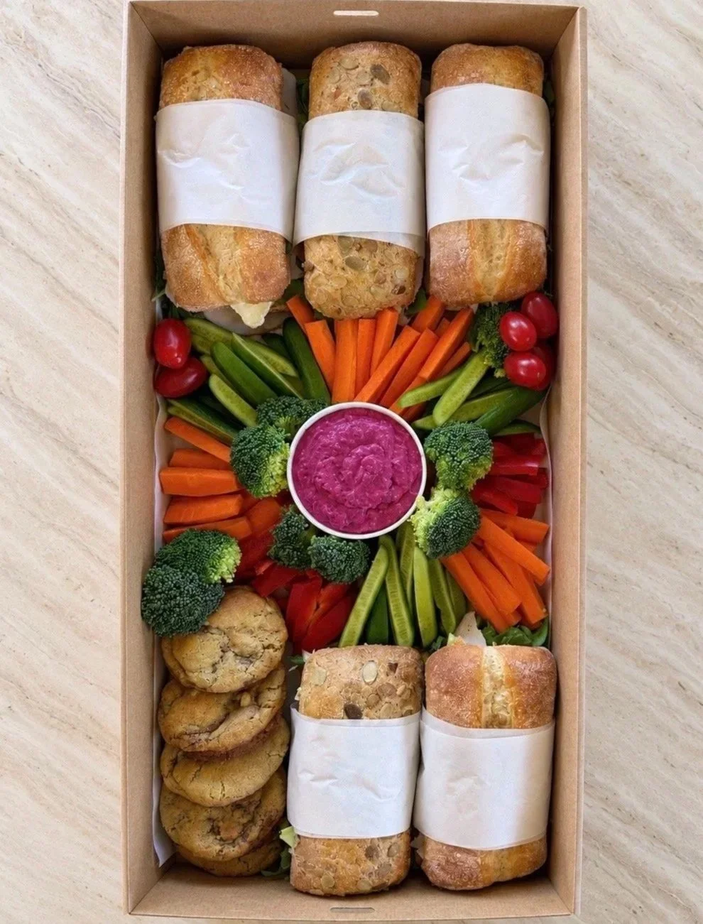 Fresh lunch box catering with gourmet rolls, crudités, dips and sweet treats by Salt & Silk Collective, offering corporate catering, event catering and grazing boxes in Airlie Beach and the Whitsundays.