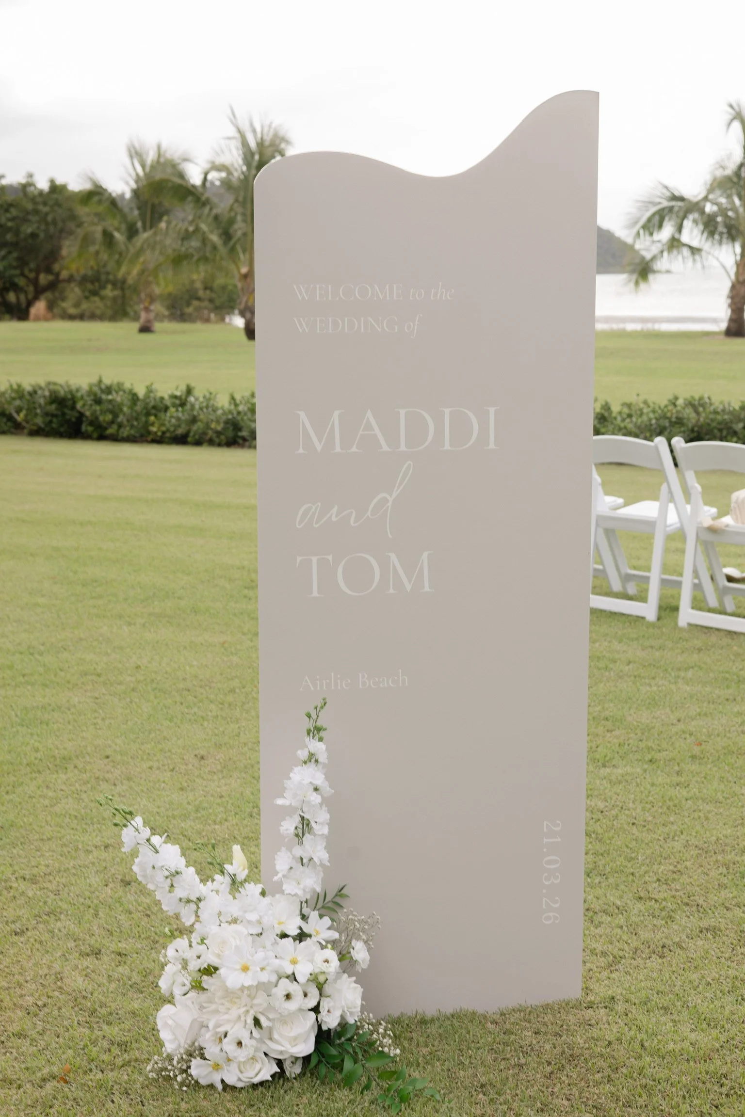 Luxury wedding welcome sign with white floral styling for an outdoor ceremony in Airlie Beach, Whitsundays by Salt & Silk Collective.