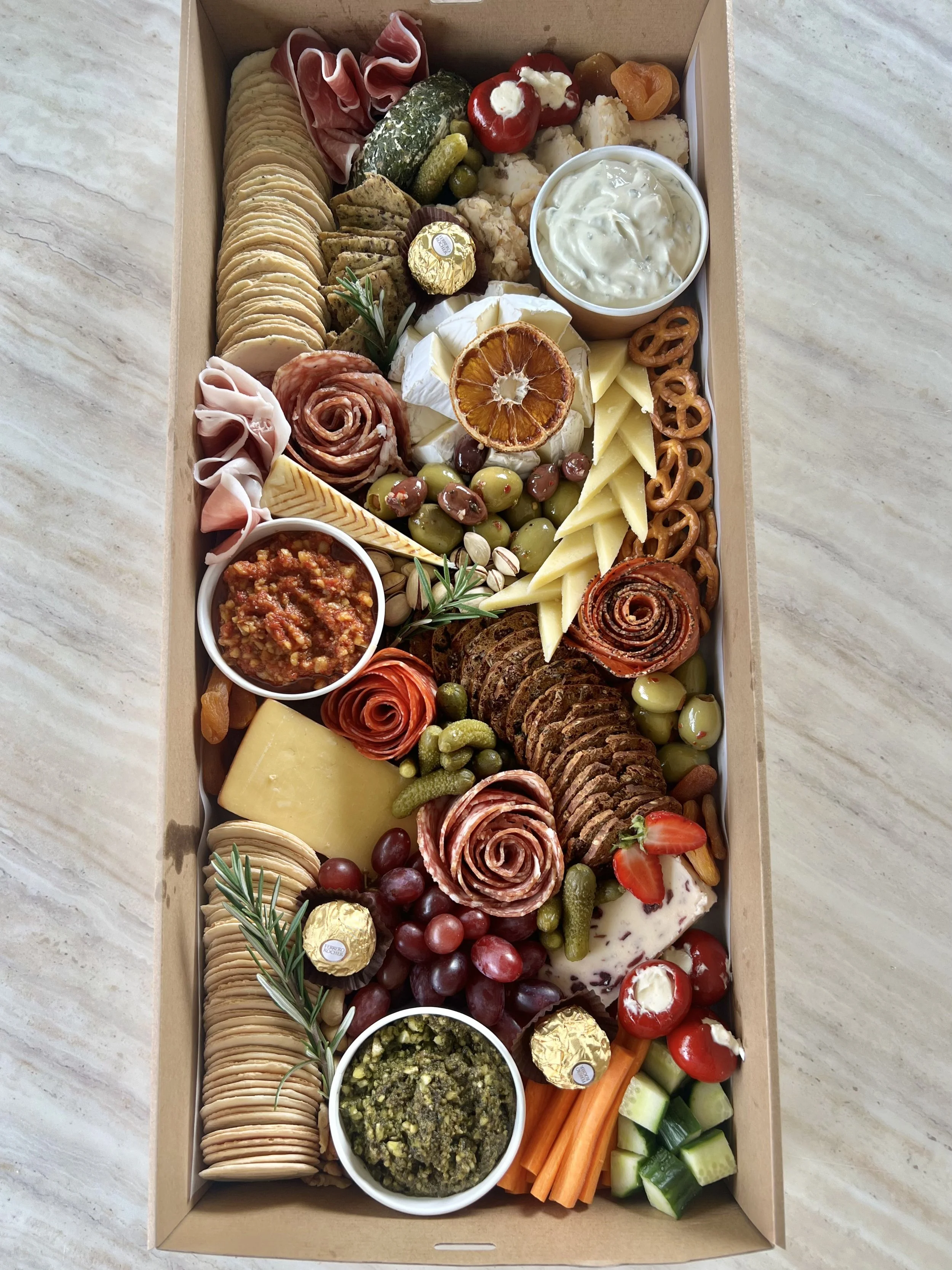 Luxury grazing box filled with artisan cheeses, cured meats, dips and fresh produce by Salt & Silk Collective, offering grazing platters, grazing tables and catering in Airlie Beach and the Whitsundays.