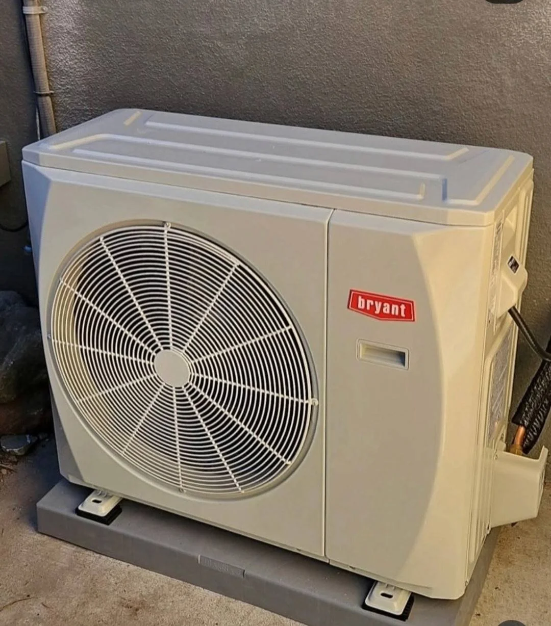 Bryant outdoor air conditioning unit on a concrete pad.
