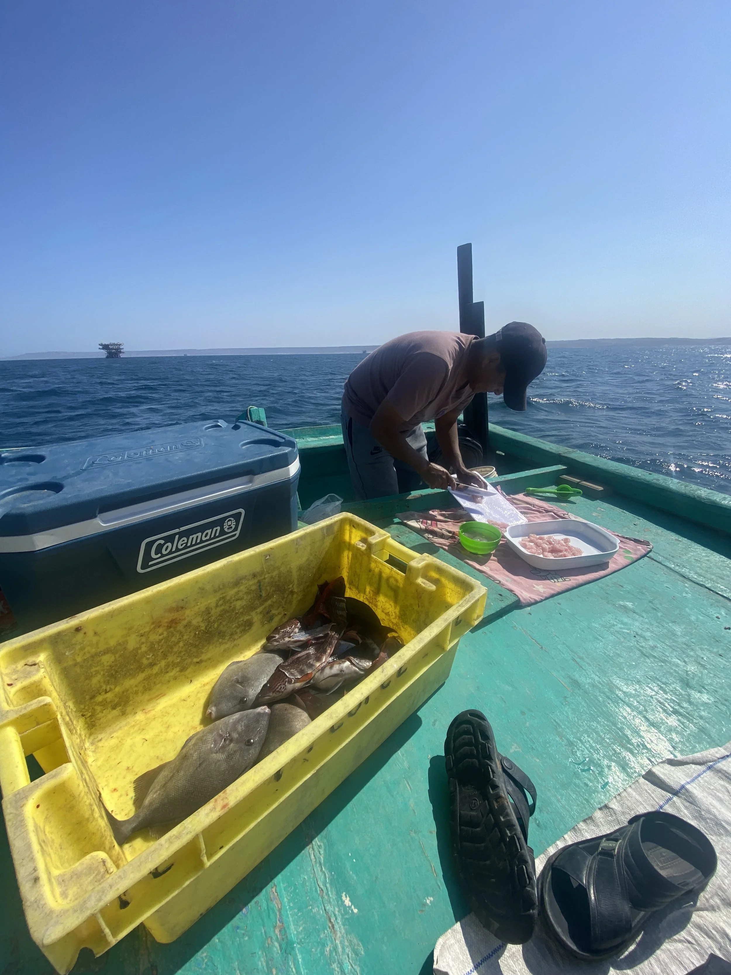 Fishermen in Lobitos, Peru prepare fresh ceviche on the boat, 2022.