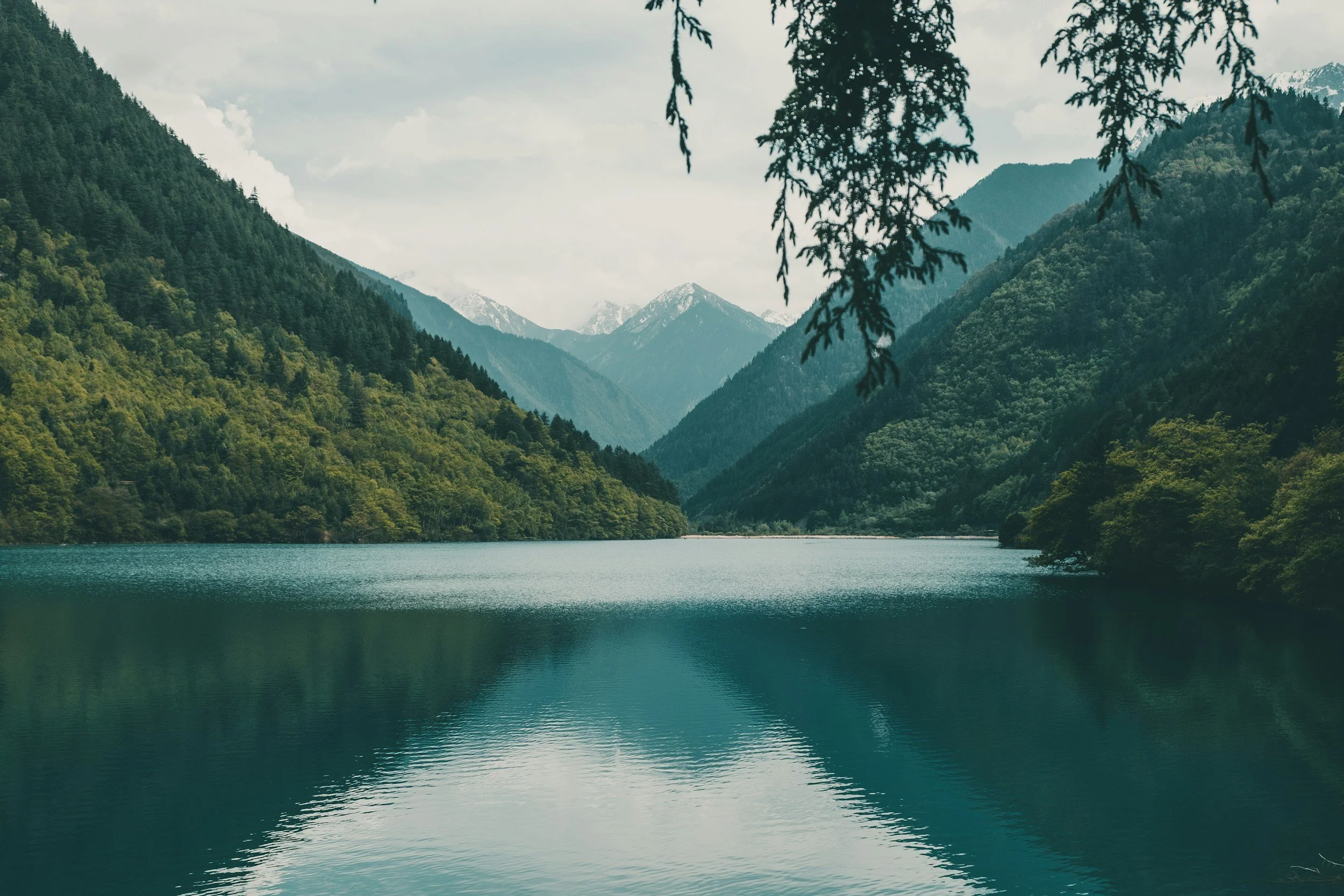 A peaceful mountain landscape reflected in a still lake, symbolizing clarity, stability, and growth in the therapeutic journey