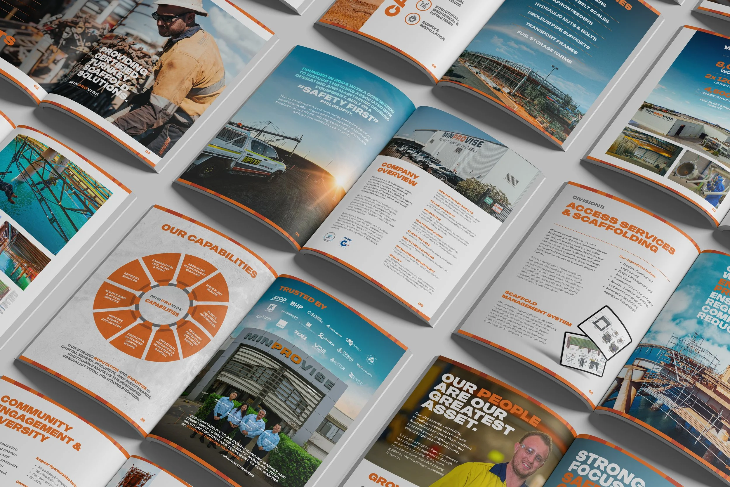 Open magazine pages featuring construction and industrial company information, including images of workers, vehicles, infrastructure projects, and company overview sections.