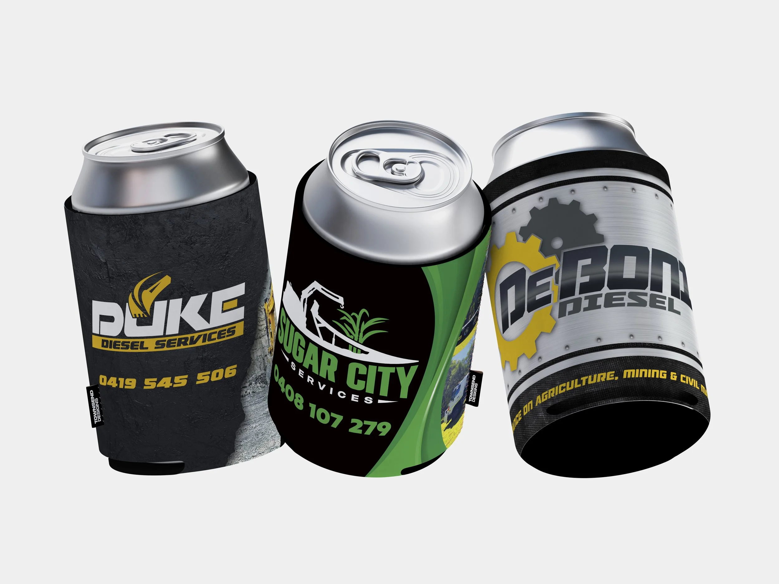 Close-up of three aluminum cans with branded soy beverage, energy, and service labels, wrapped in black, green, and gray sleeves.