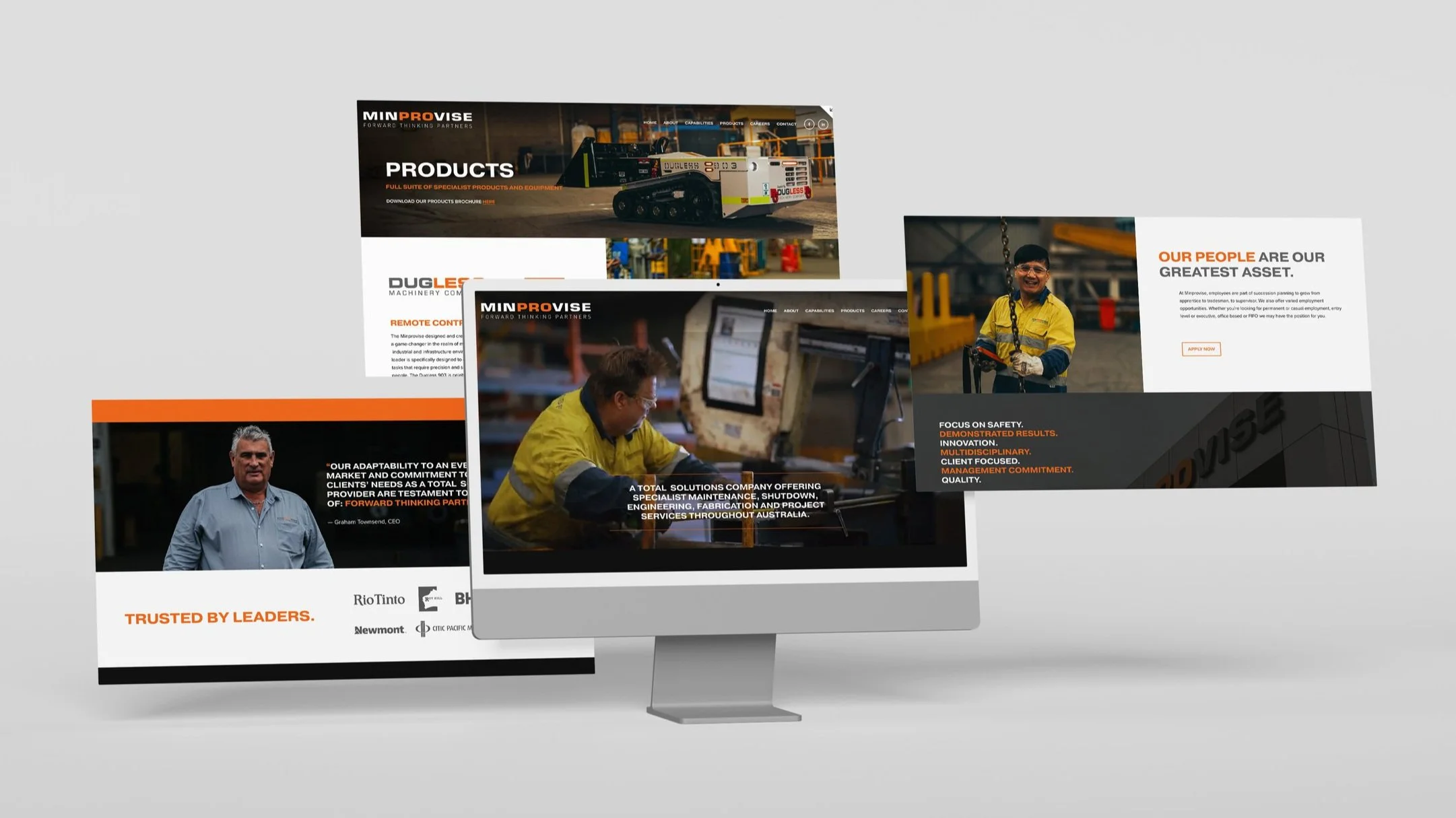Multiple computer screens displaying a website for Minprovise, a company specializing in industrial machinery and services, with images of machinery, workers, and company information.