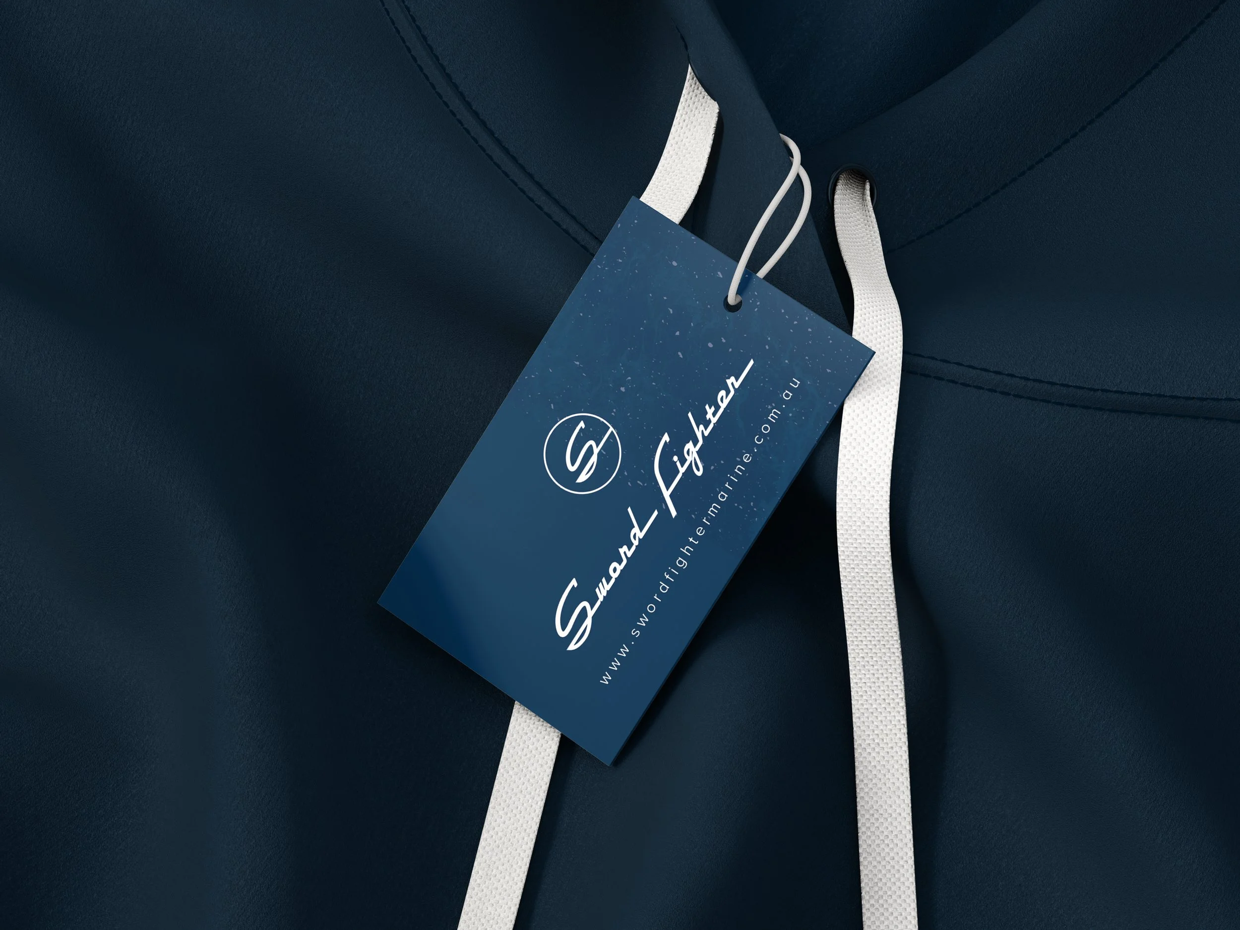 Close-up of a navy blue fabric with a white drawstring and a blue tag that reads 'Swordfish' along with a logo and website address.