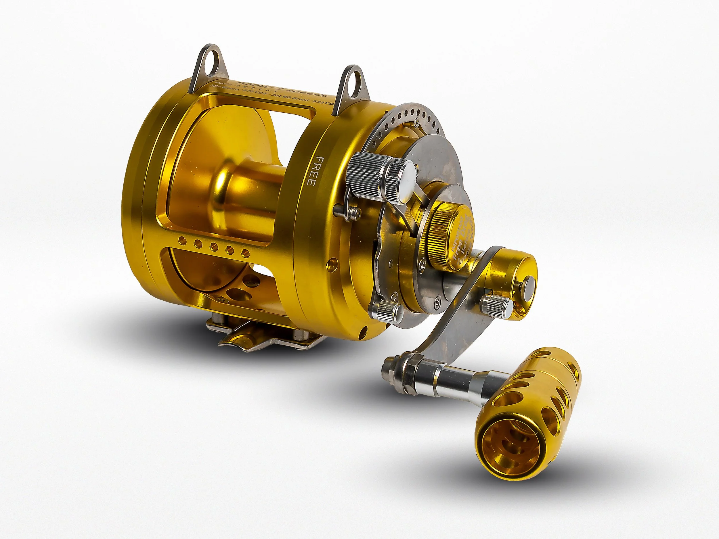 A gold fishing reel with a matching gold handle and silver components, set against a plain white background.