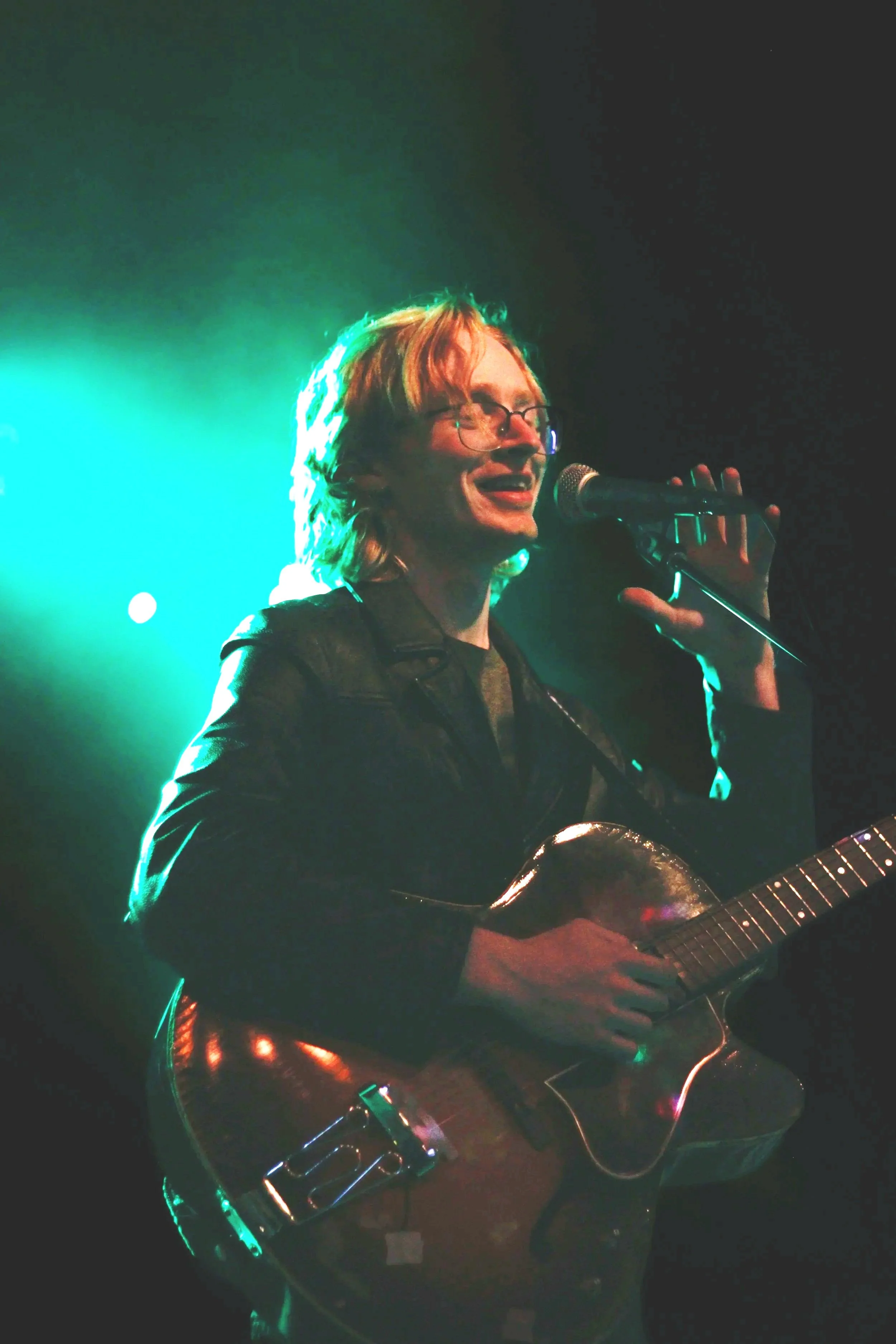 Brendan Coller singing an playing guitar